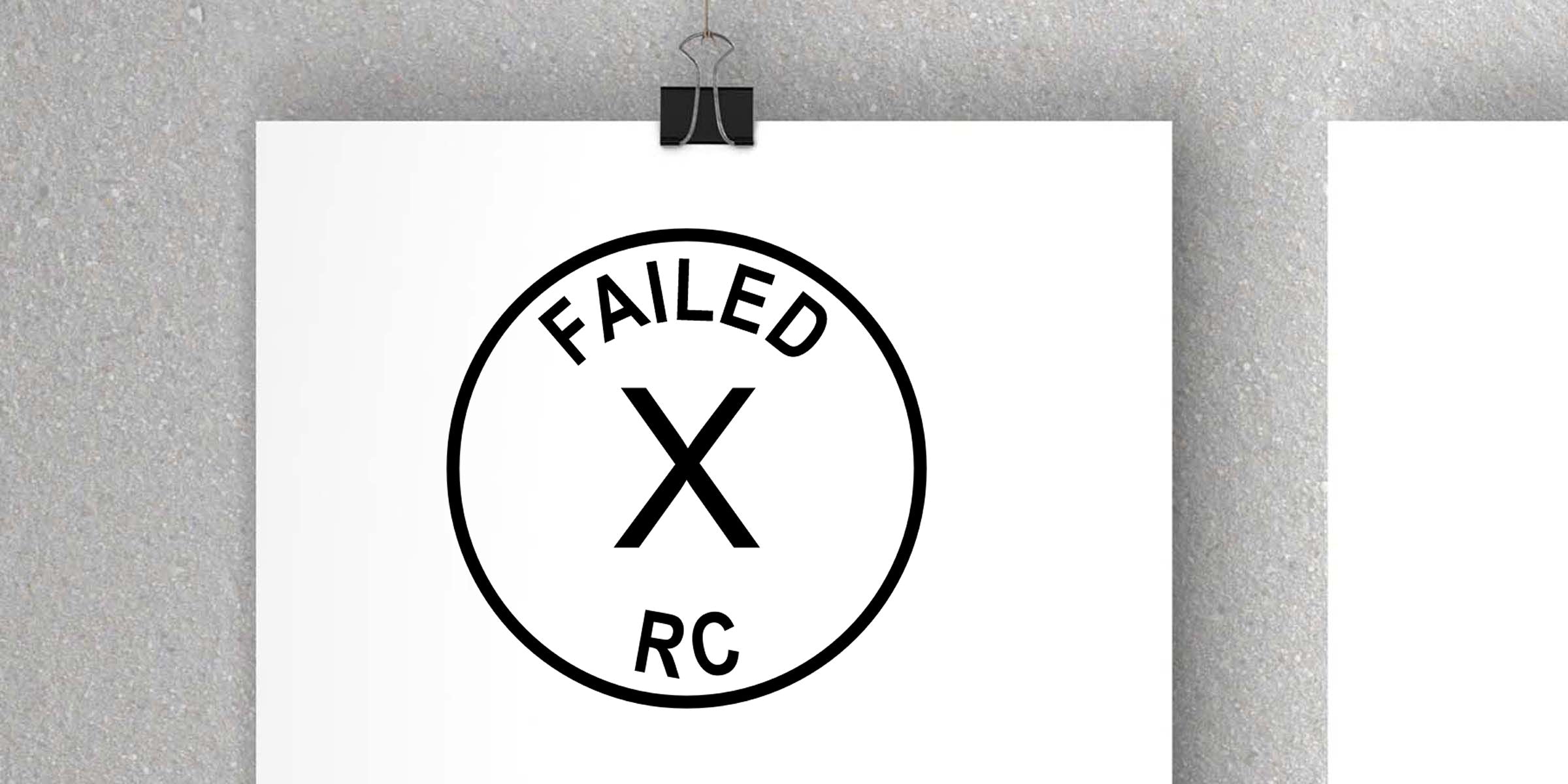 Minimalist black-and-white FAILED X RC logo poster clipped to a textured gray wall with a binder clip