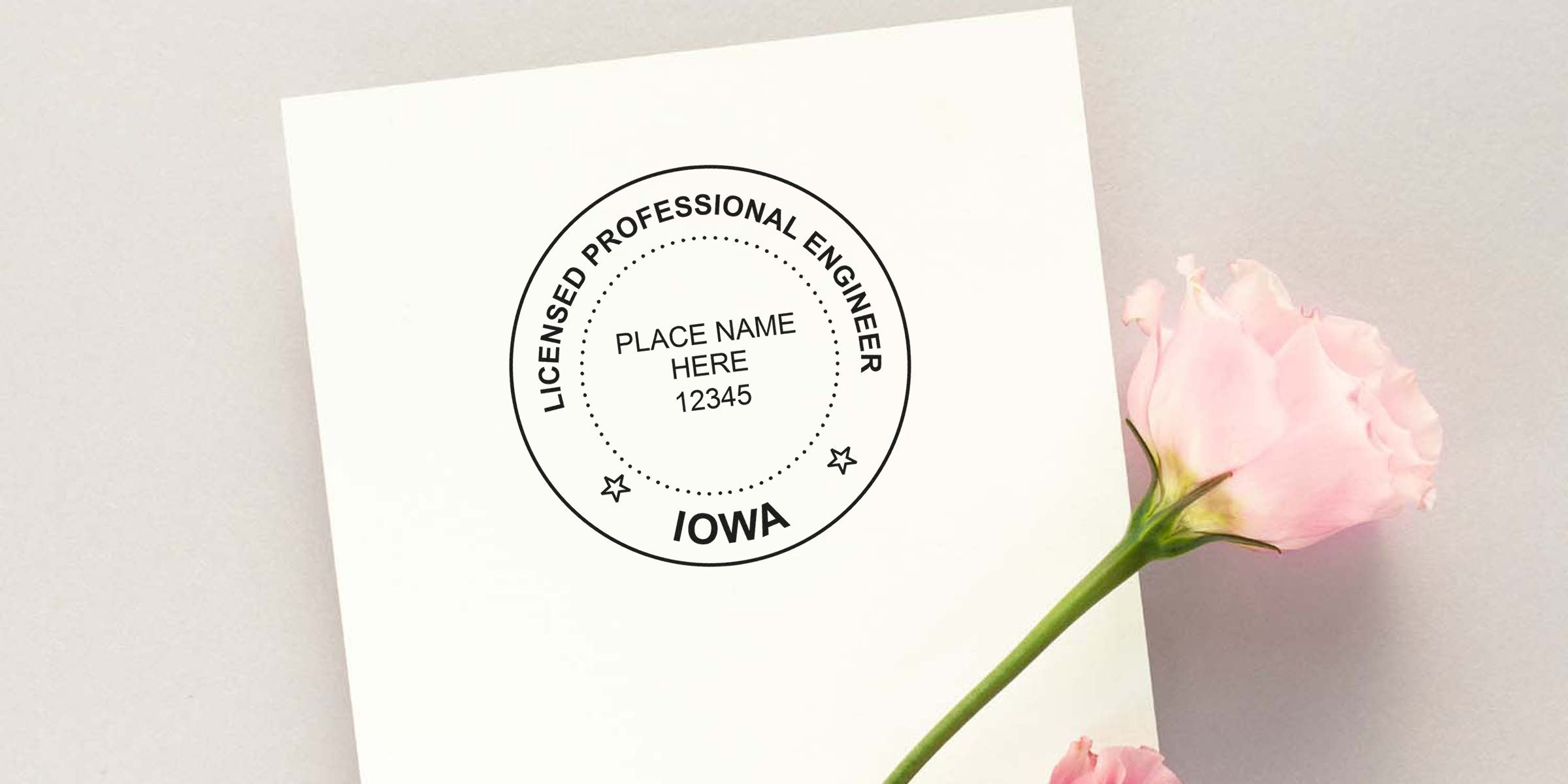 Self-inking Iowa engineer stamp with licensed professional engineer seal and pink rose on white paper.
