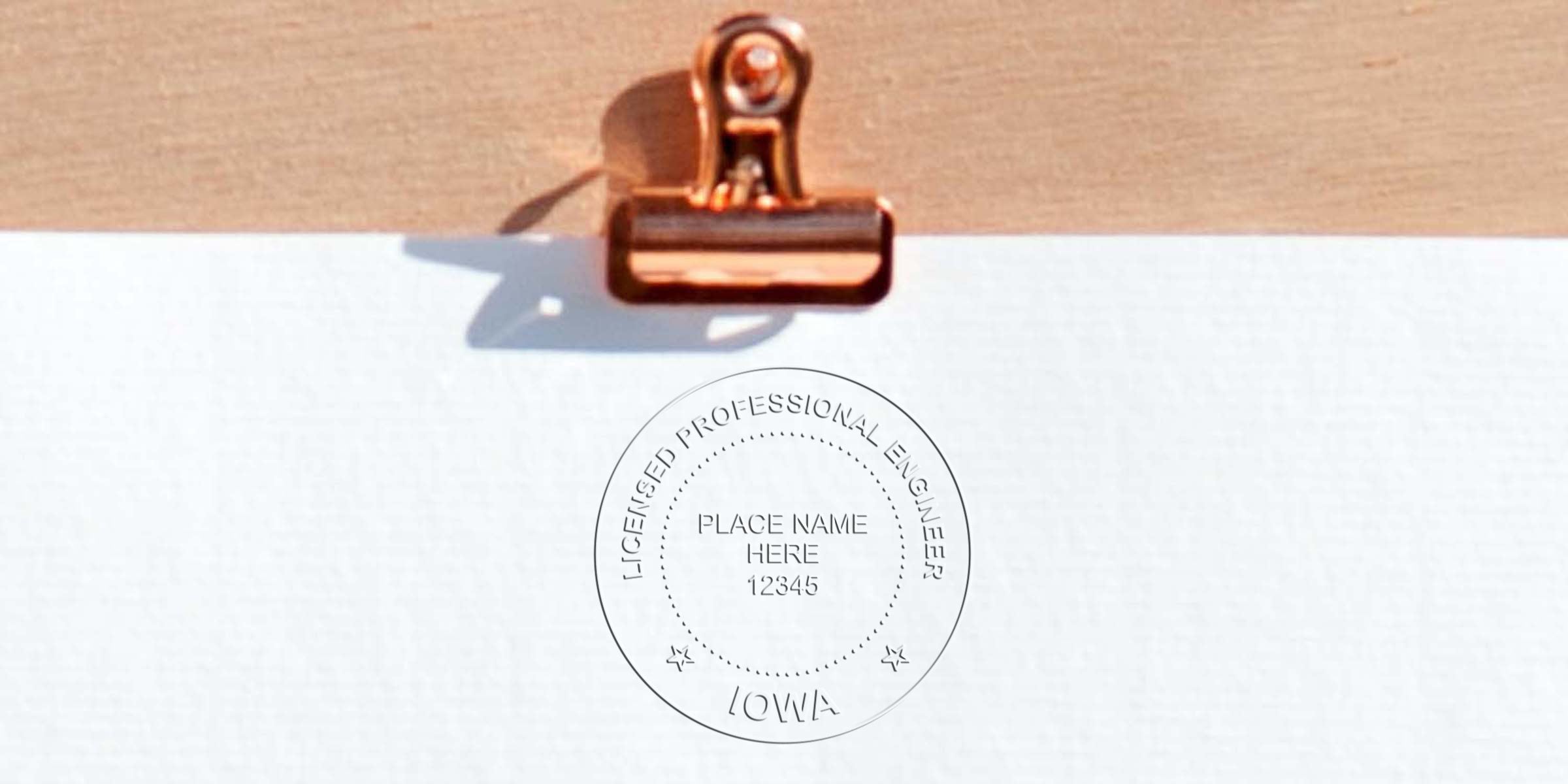 Iowa engineer seal embosser creating a licensed professional engineer stamp on white paper with a copper clip.