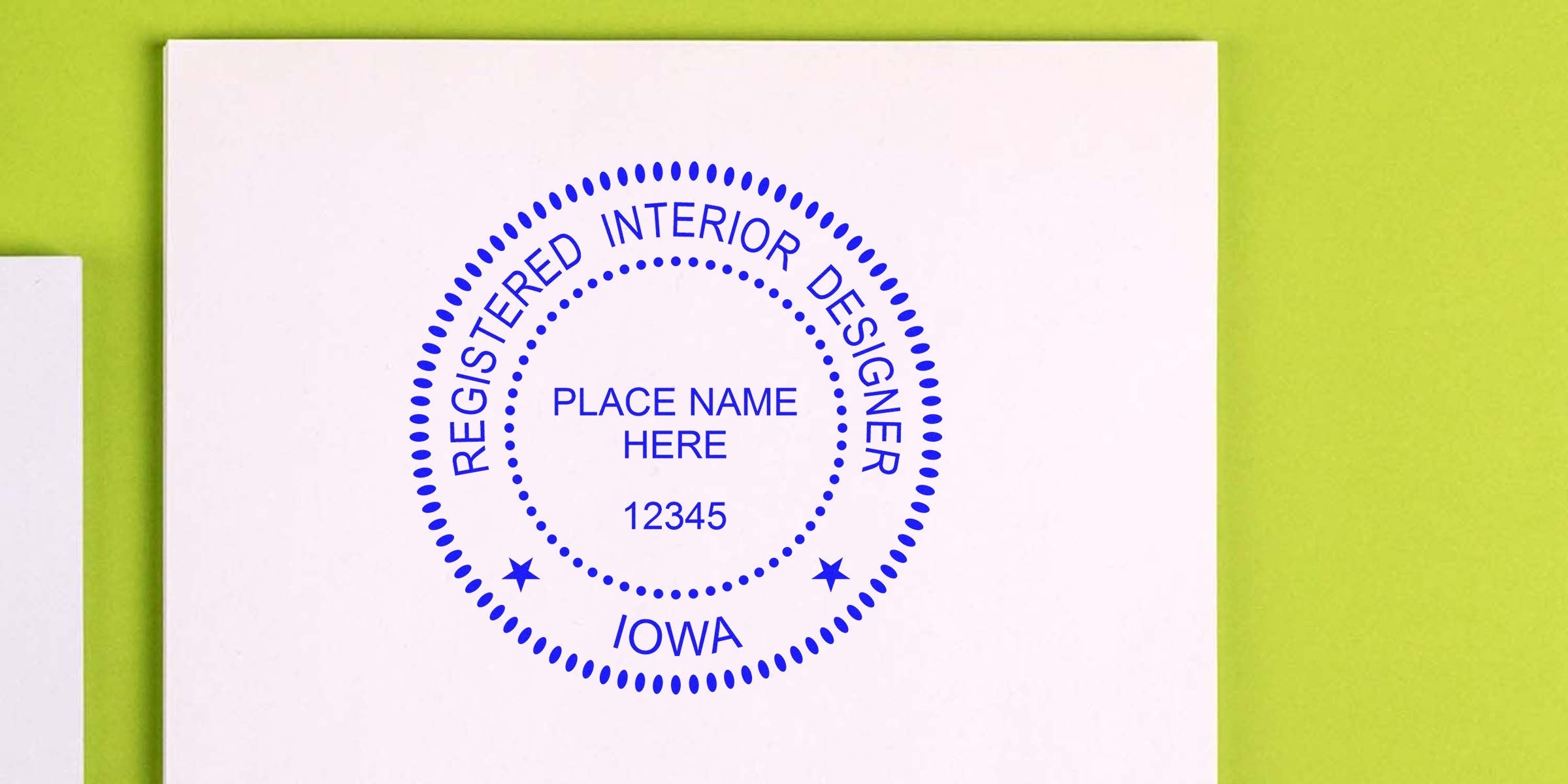 Iowa interior designer’s seal embossed on white paper with an embossing tool for certification.