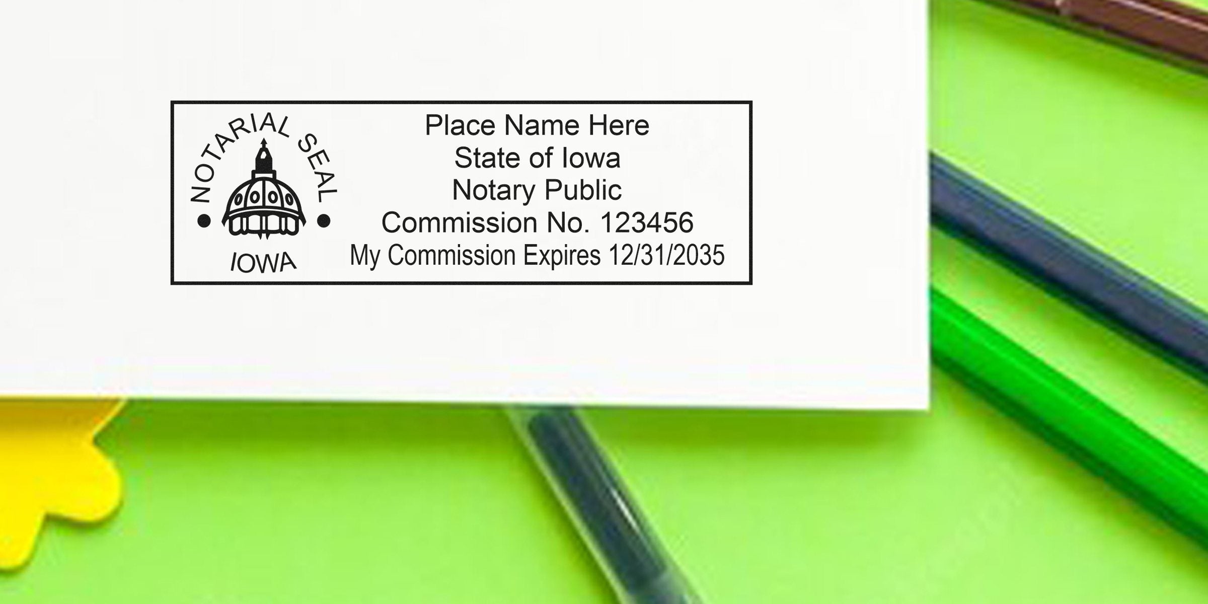 Iowa notary stamp on document, surrounded by green and yellow notary supplies and IA notary tools.