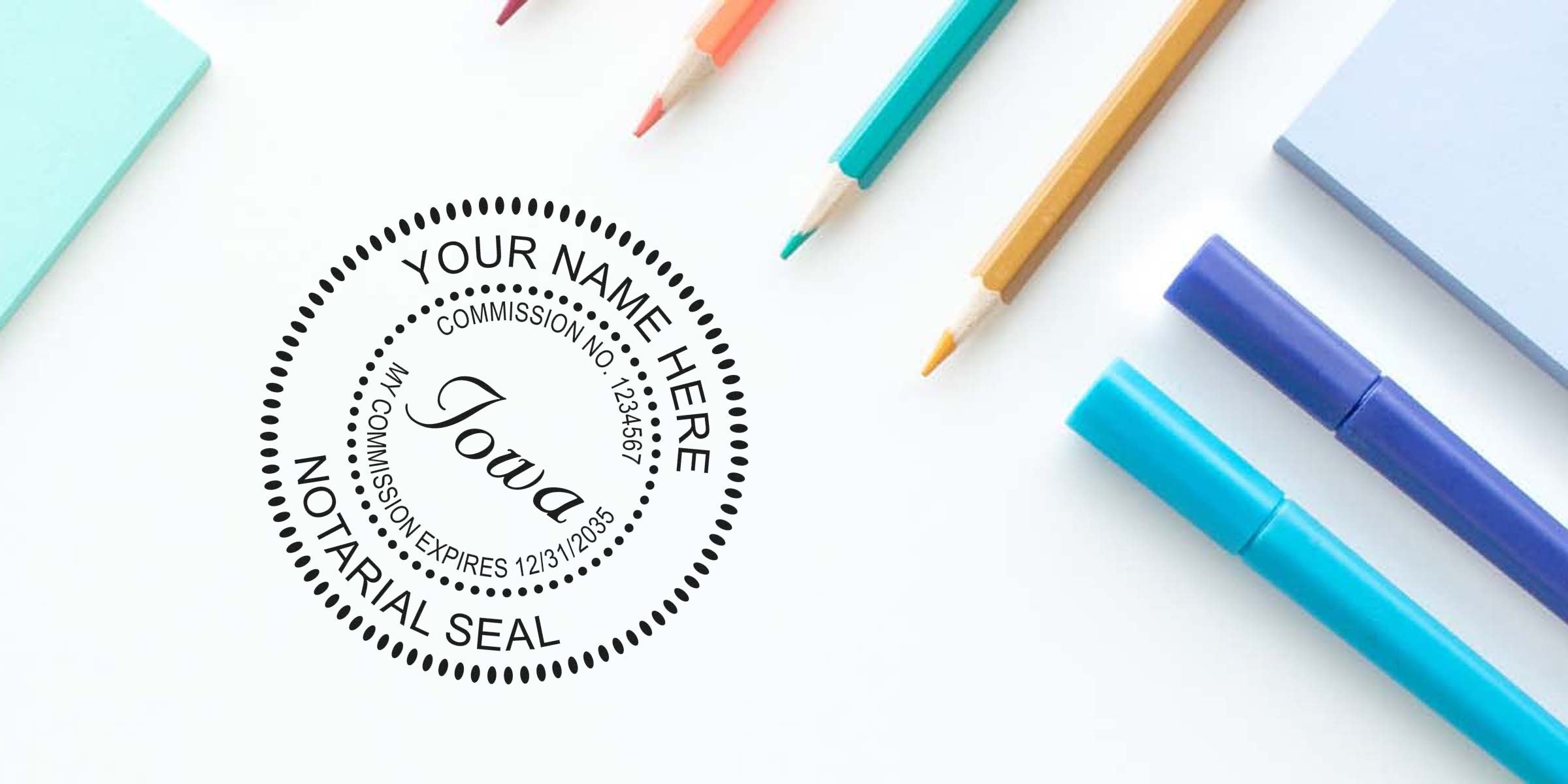 Iowa notary seal surrounded by colored pencils and markers on a white desk, highlighting essential and reliable Iowa notary supplies.