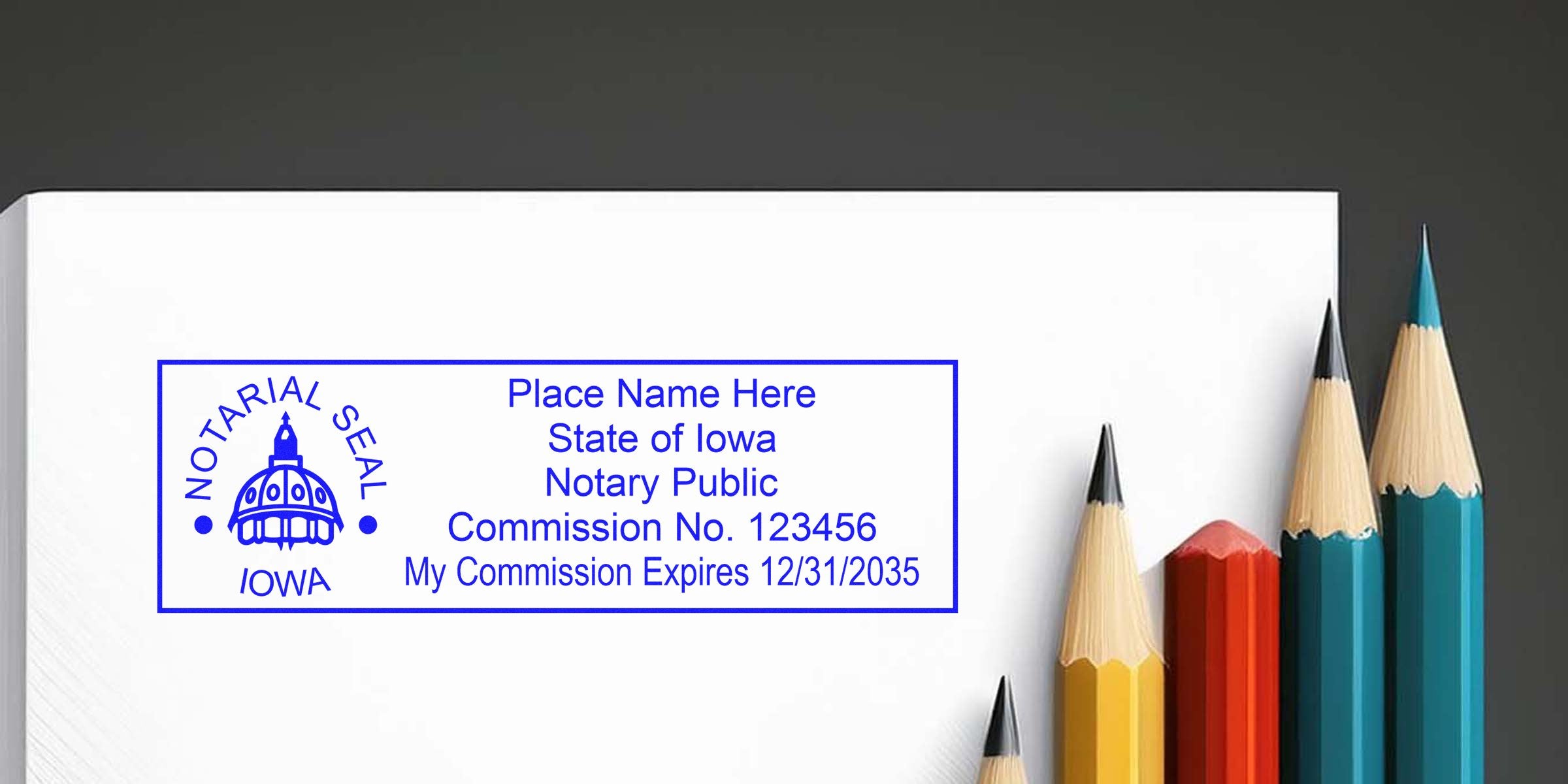 Iowa notary seal on white paper with colorful pencils, showing official commission expiration date and essential notary supplies.