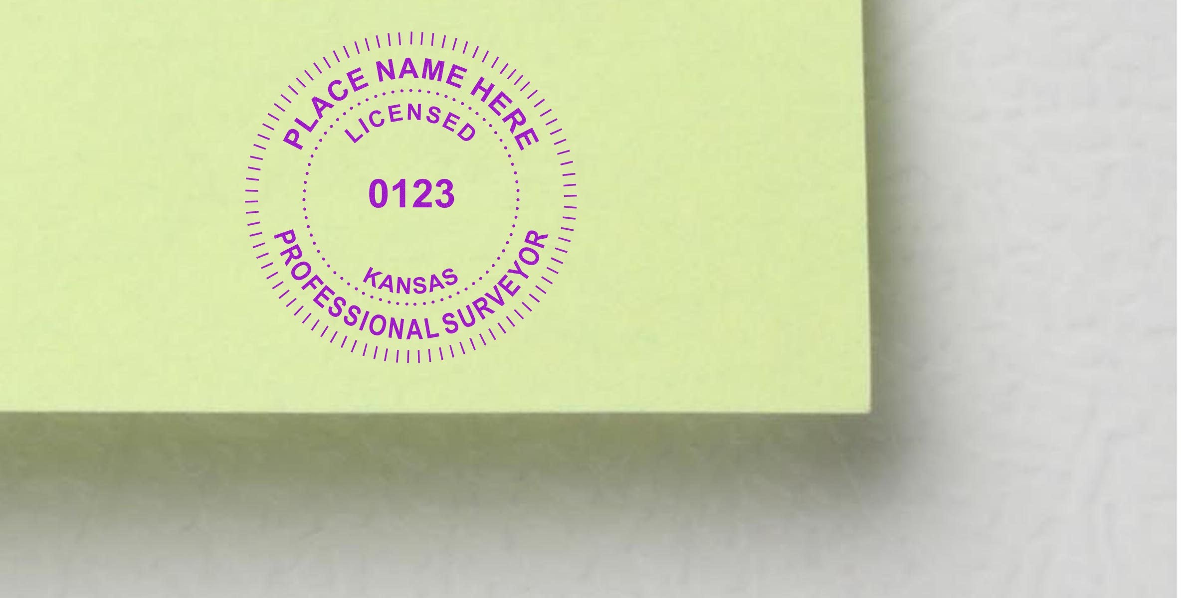 Kansas land surveyor stamp with license number 0123 on yellow paper, representing professional land surveyor licensing in Kansas.