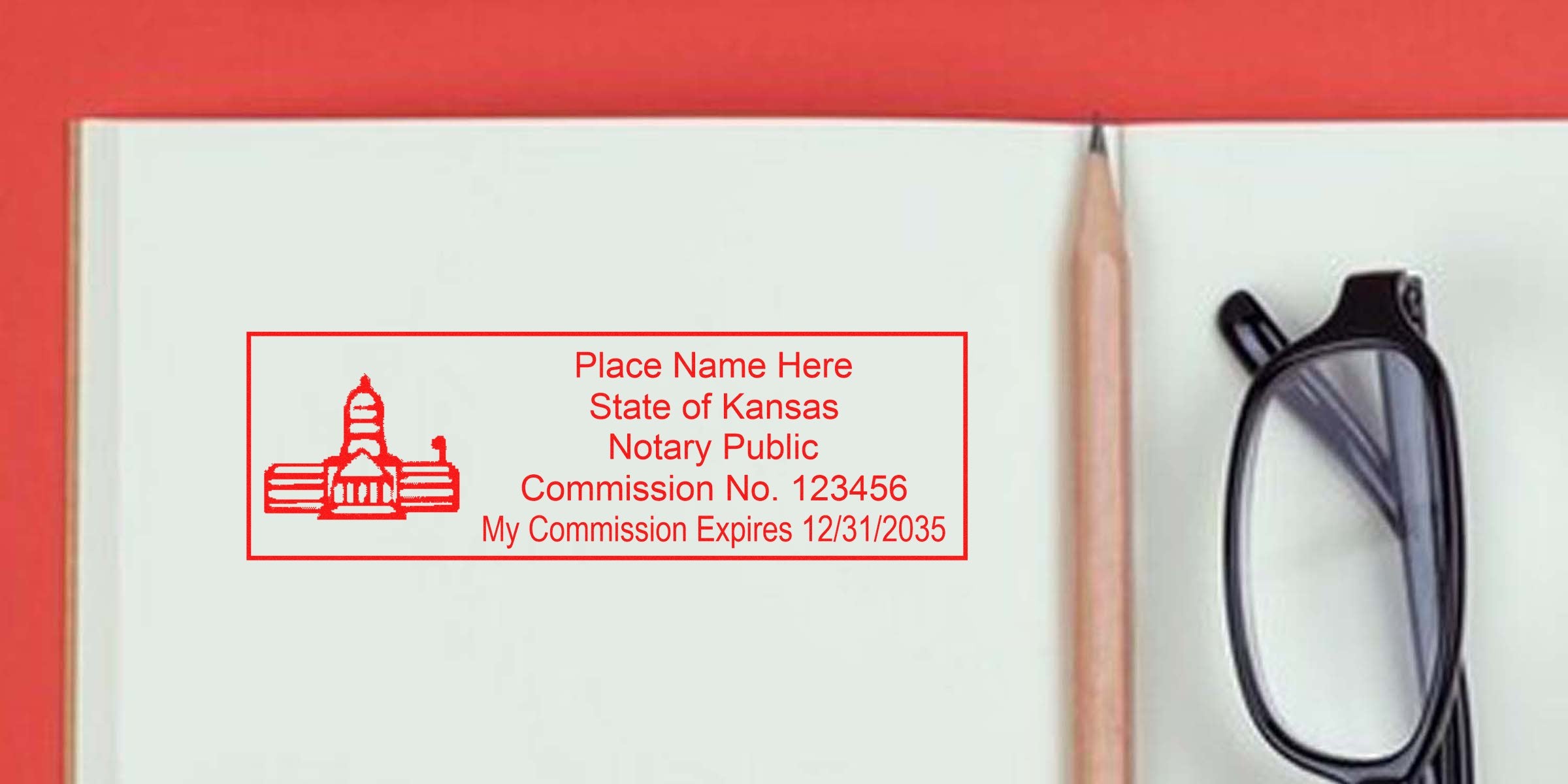 Kansas notary public stamp with commission number and expiration date on open notebook, next to pencil and black glasses, highlighting trusted Kansas notary supplies and reliable notary products.
