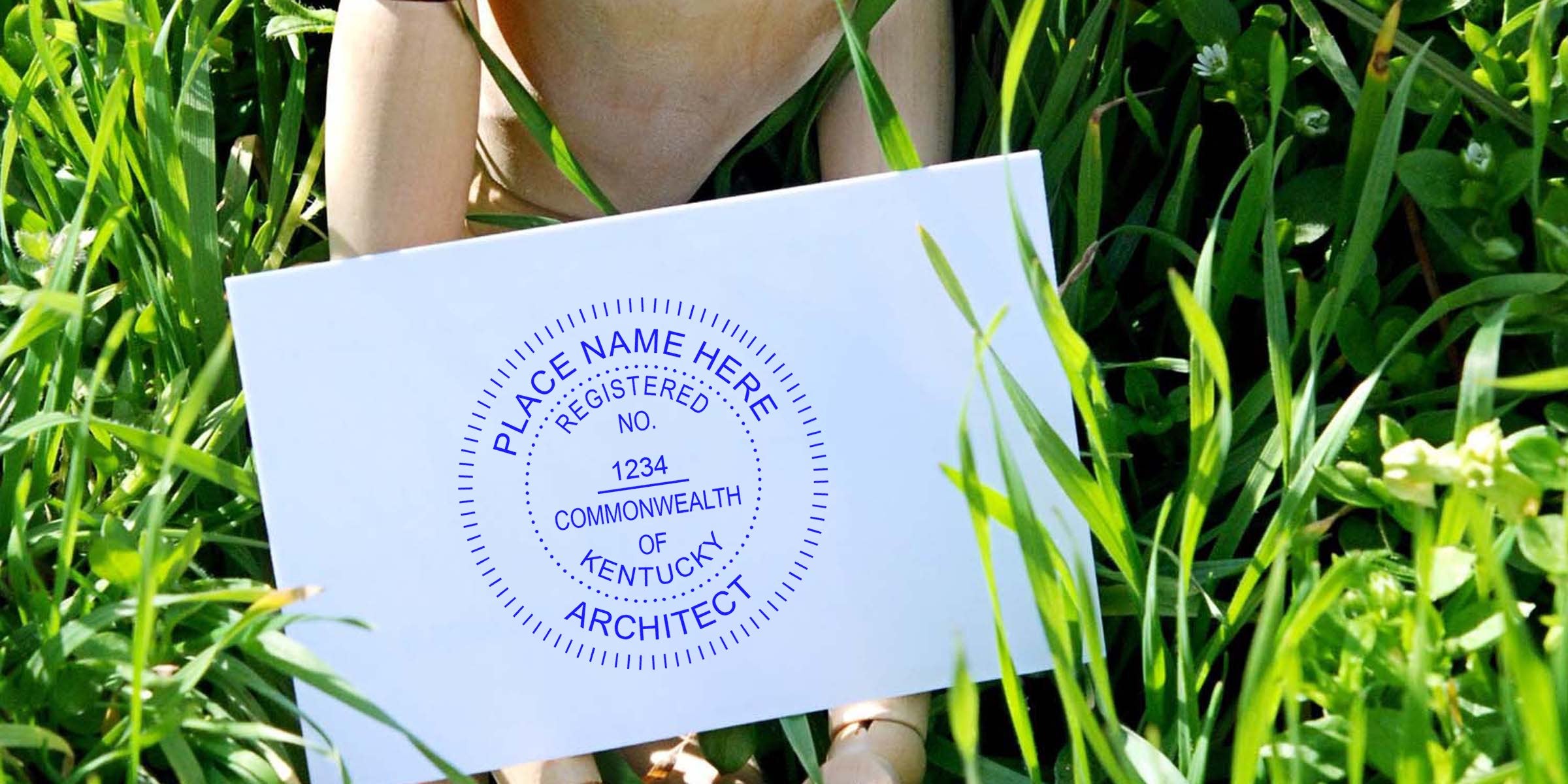 Kentucky architect seal stamp on white paper in green grass, emphasizing the importance of selecting an architect seal in Kentucky.