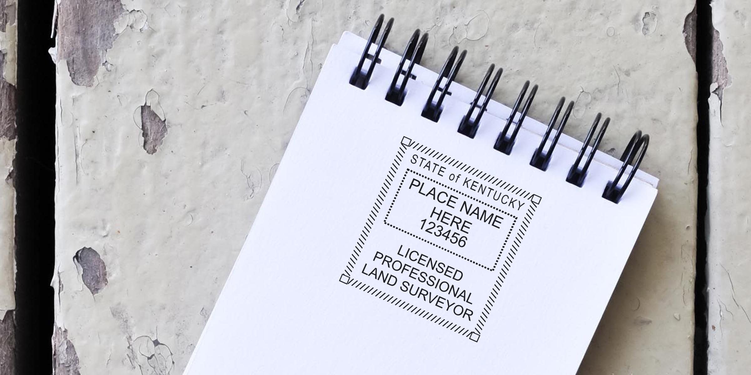 Kentucky licensed professional land surveyor notepad with surveyor stamp and certification on rustic wooden surface.