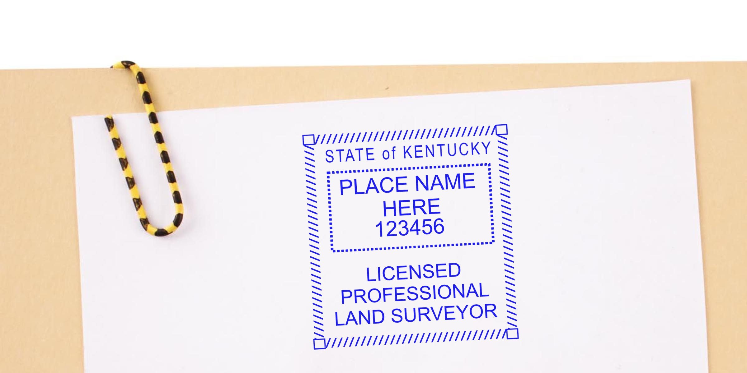 Kentucky land surveyor seal embossed on white paper with a yellow and black paperclip, showing the Kentucky licensed professional land surveyor embosser.