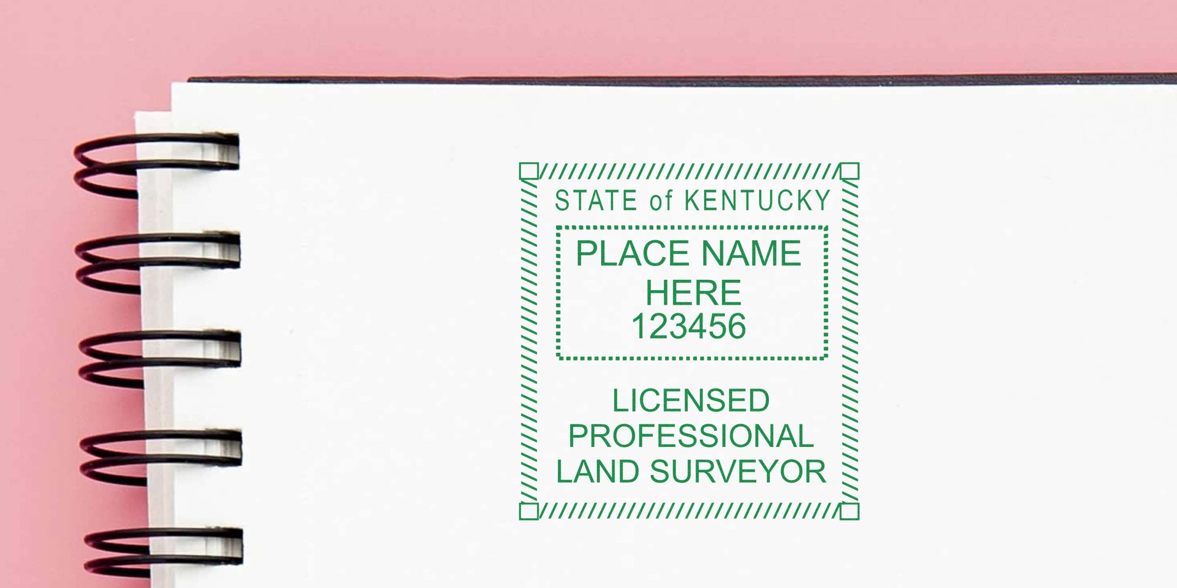 Kentucky land surveyor stamp on white spiral notebook with pink background, showing the stamp and its requirements.