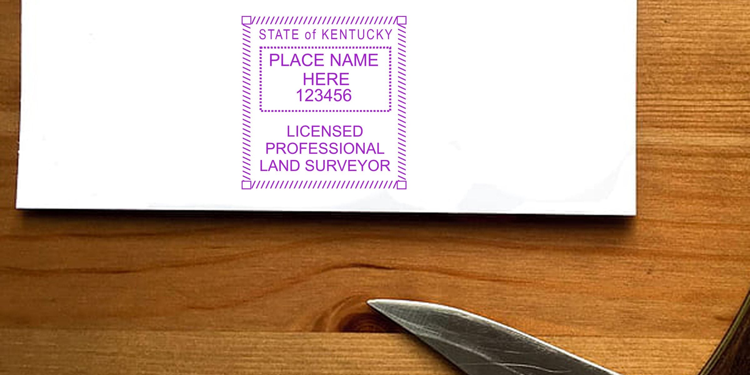 Kentucky licensed professional land surveyor stamp on white paper with wooden background and knife edge, showing Kentucky land surveyor stamp laws and regulations.