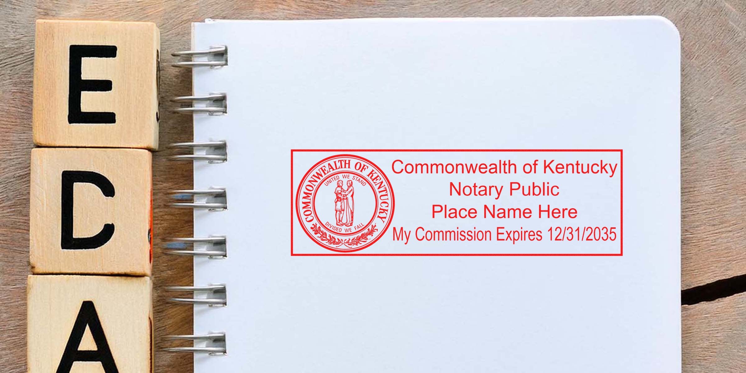 Kentucky notary public stamp and KY notary seal on a white notebook with ECA wooden blocks on a wooden table.