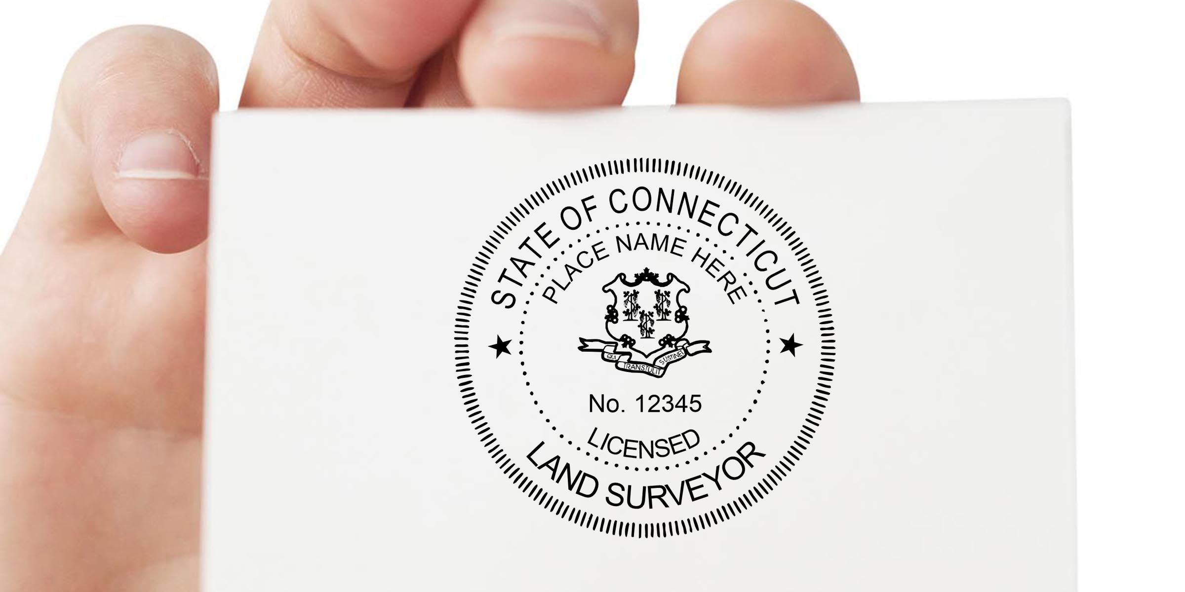 Hand holding white card with Connecticut licensed land surveyor seal, placeholder name, and license number 12345