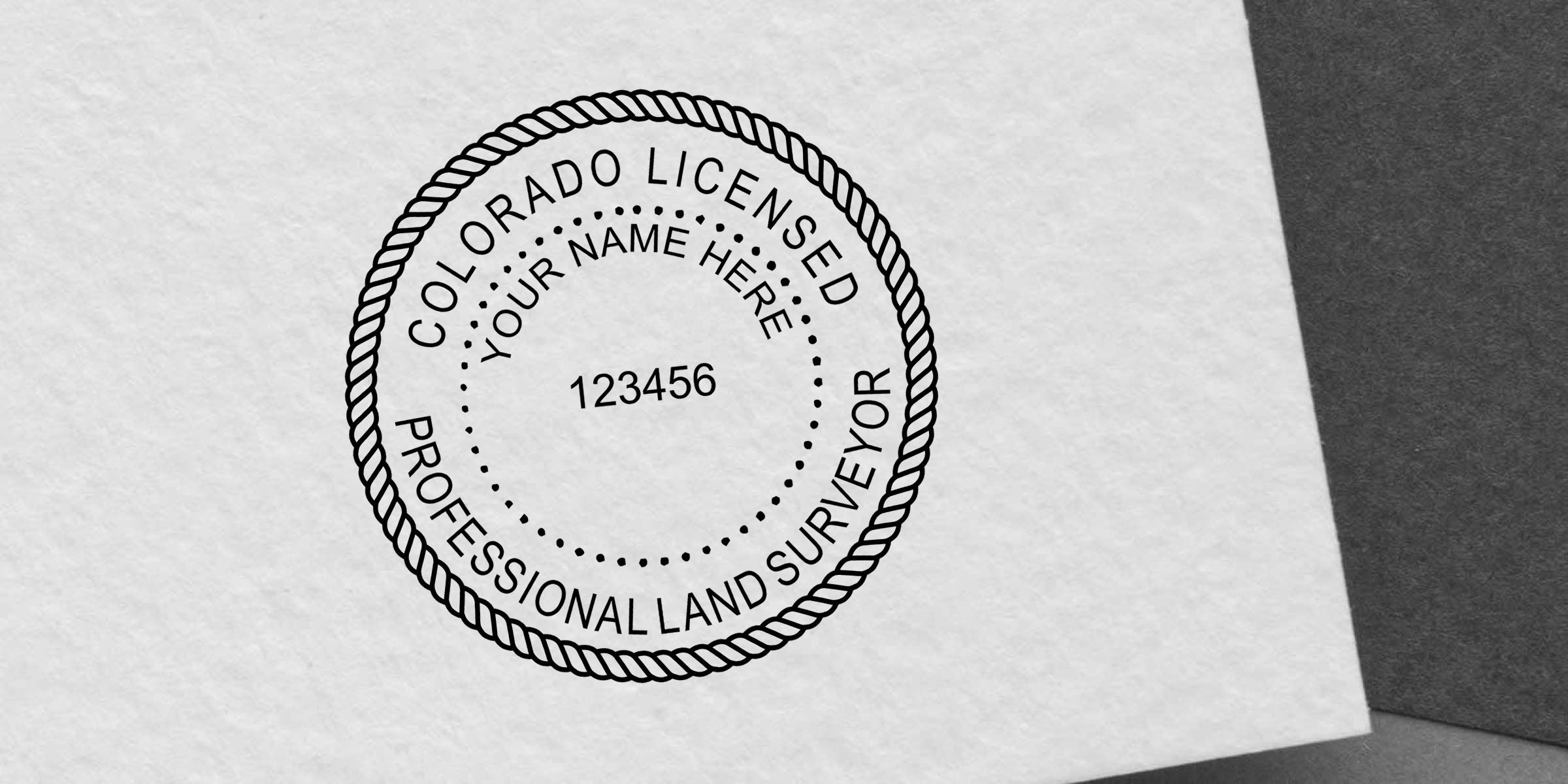Colorado licensed professional land surveyor seal stamp with placeholder name and registration number 123456 on white paper