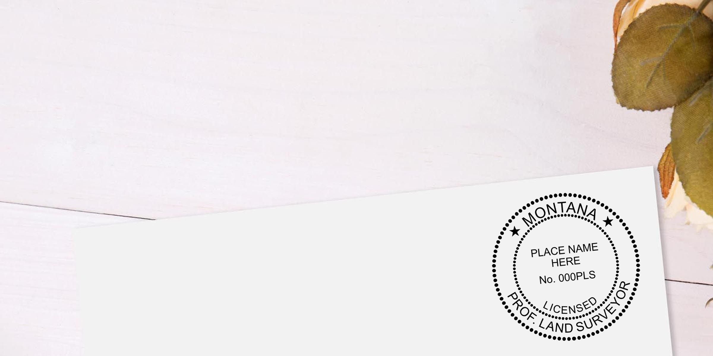 White paper background with a circular Montana licensed professional land surveyor stamp and dried leaves in the corner
