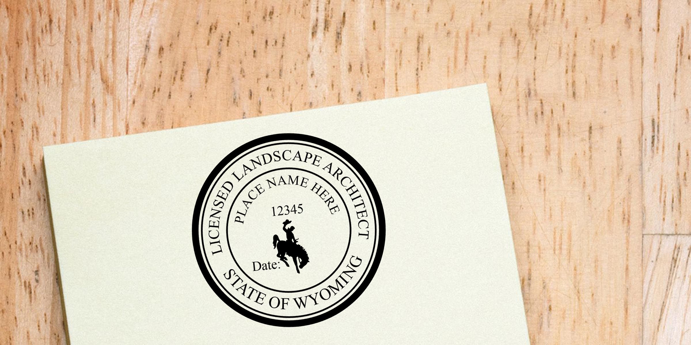 Licensed landscape architect State of Wyoming seal on a white business card on a wooden surface, with placeholder name, number, and date fields