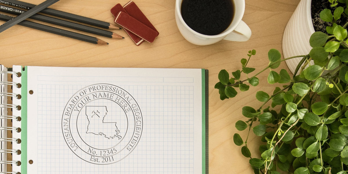 Louisiana Board of Professional Geoscientists seal on graph paper notebook with pencils, erasers, coffee cup, and green plant on wooden desk, highlighting geologist stamp and purchase tips.
