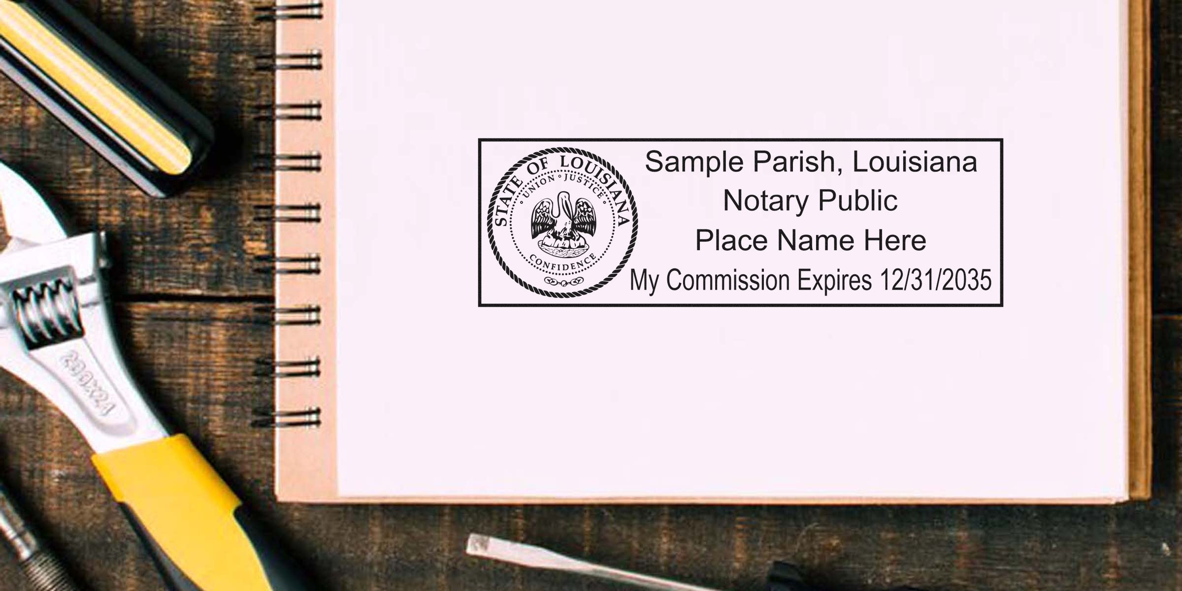 Louisiana notary stamp on notebook with wrench and screwdriver on wooden table, showcasing budget-friendly notary supplies.