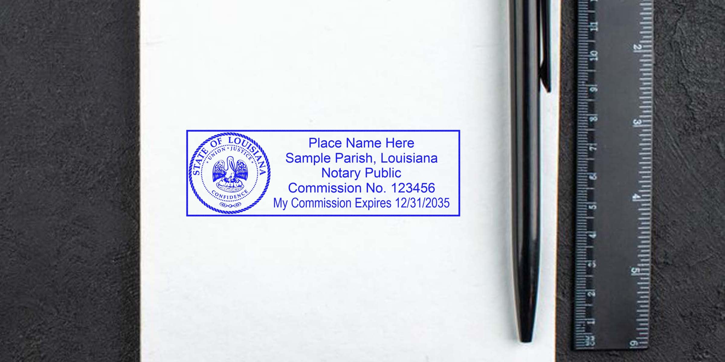 Louisiana notary seal stamp with commission number and expiration date on white paper, alongside black pen and ruler, complying with Louisiana notary seal requirements.