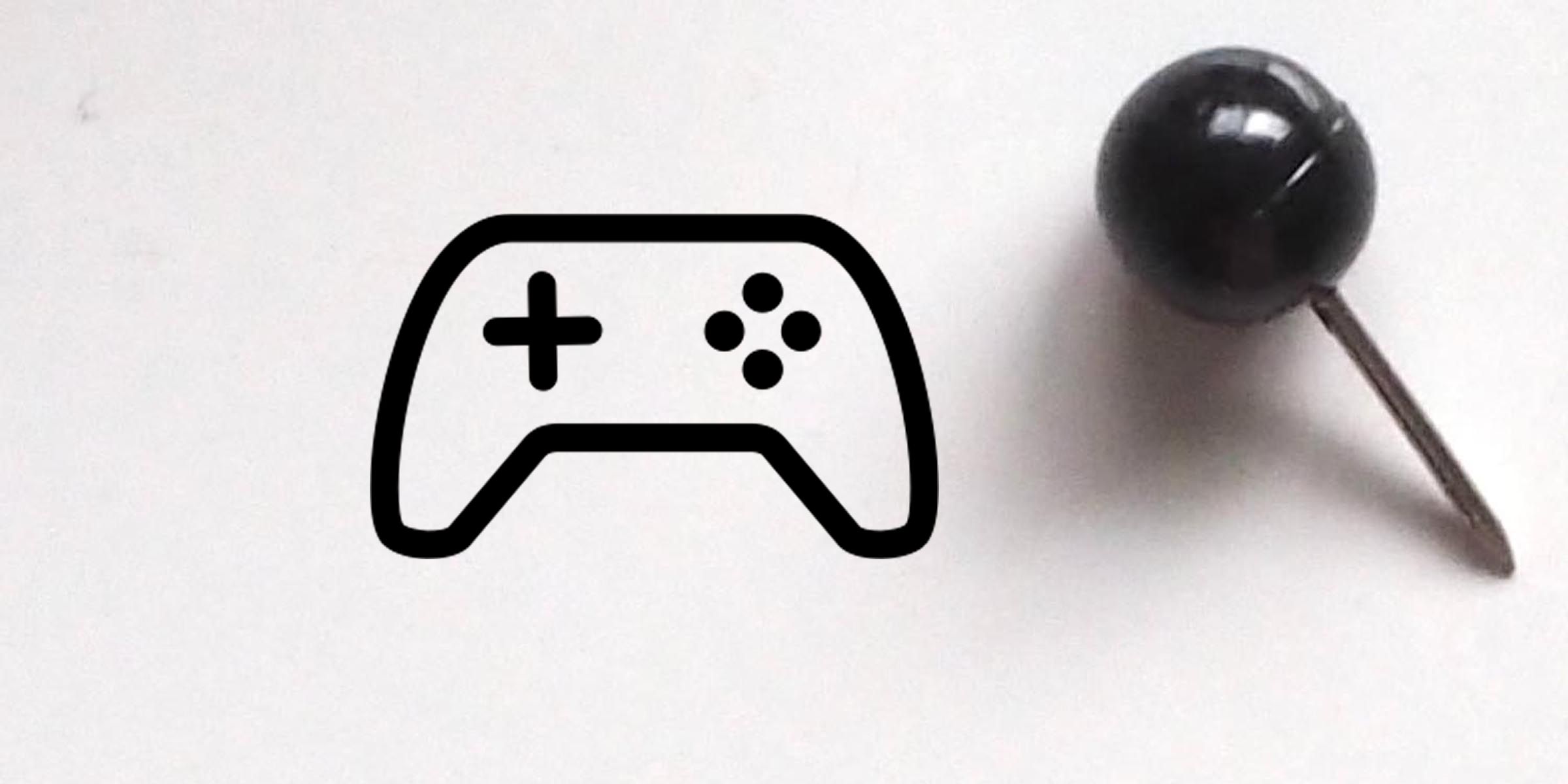 Black gaming controller icon next to a push pin on a white background, representing video game concept or pinned content icon.