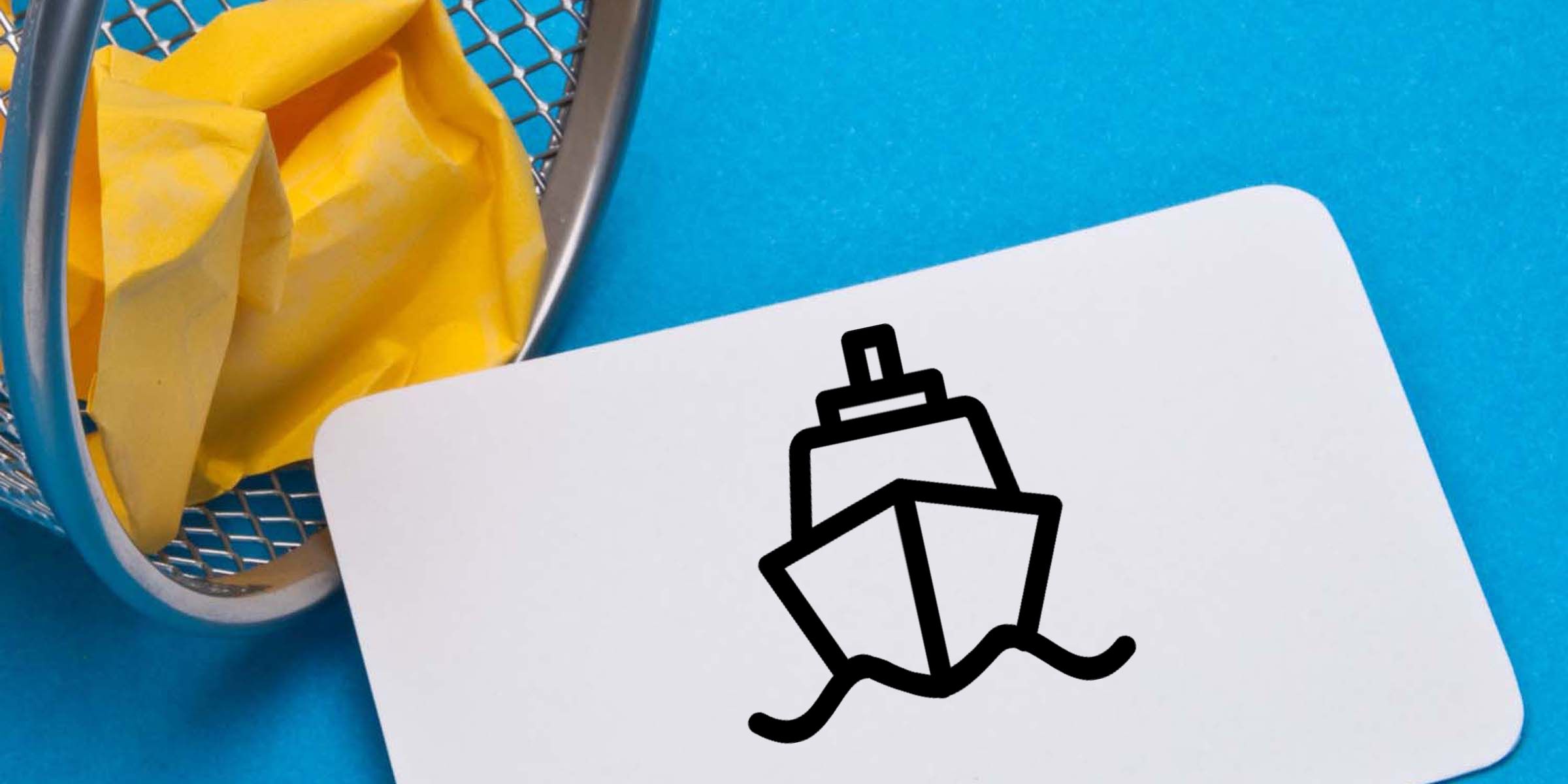 Crumpled yellow paper in a metal wastebasket beside a white card with a black line icon on a blue background