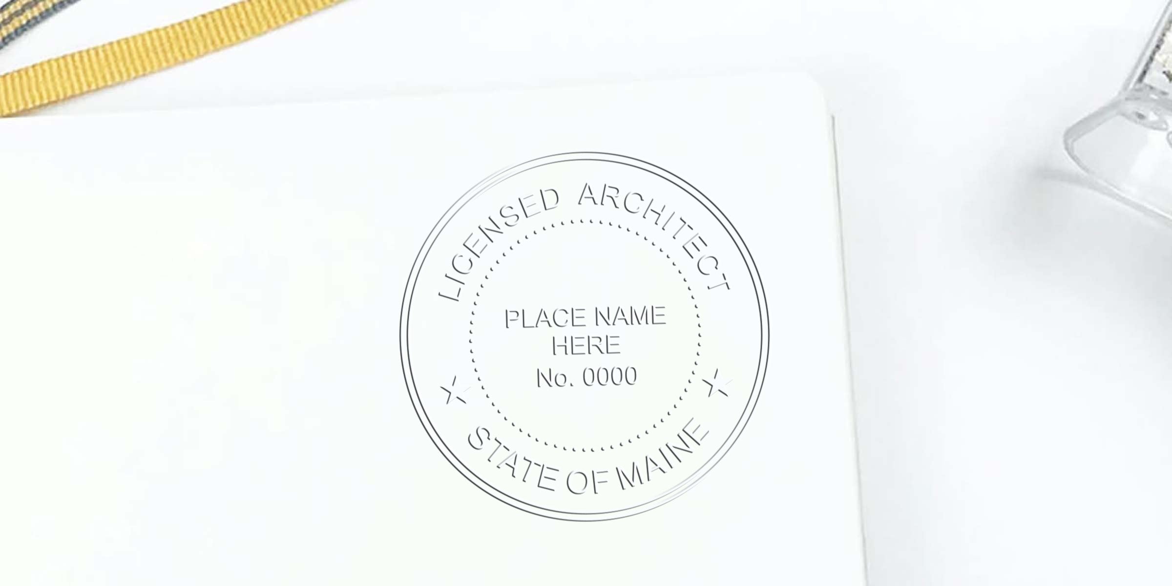 Maine architect seal embossed on white paper, licensed architect stamp for Maine with customizable location and number, detailed professional embosser.