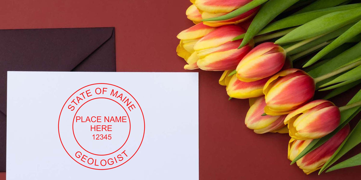 White envelope with Maine Geologist Stamp and red-yellow tulip bouquet on maroon background, highlighting unique collectible stamps.