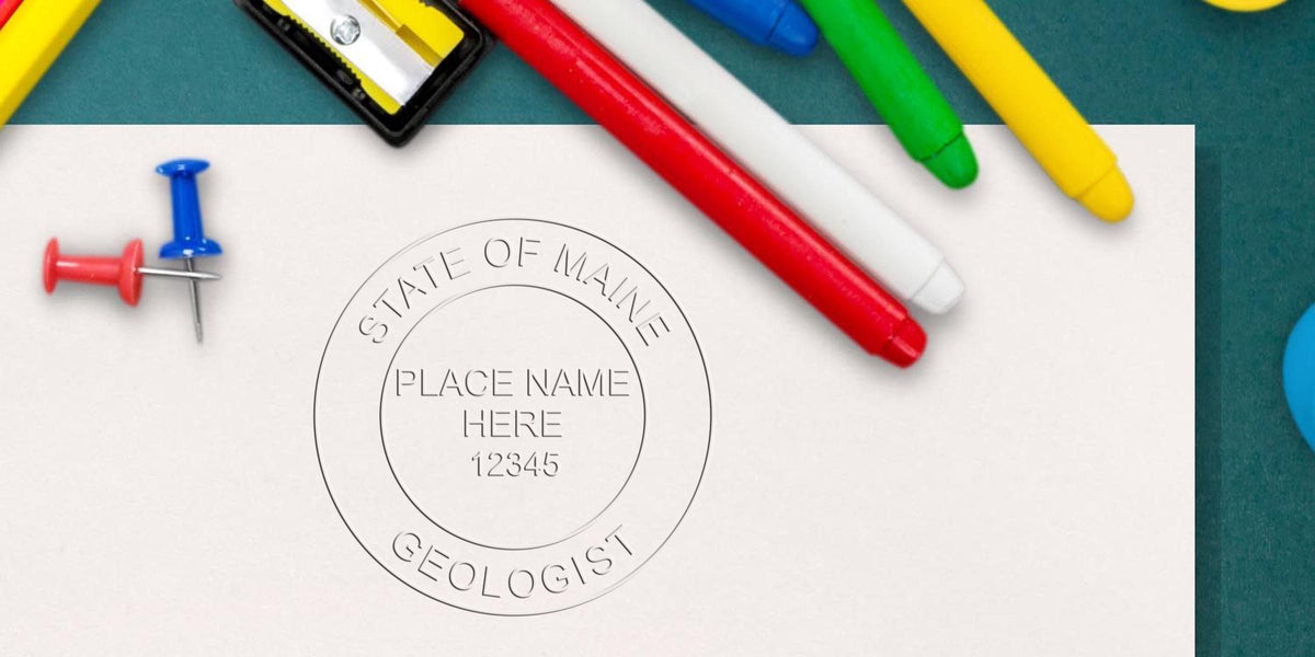 State of Maine geologist embossed seal on white paper with colorful markers and push pins, symbolizing the Best Geologist Stamp and official Maine Geologist certification for geological records.
