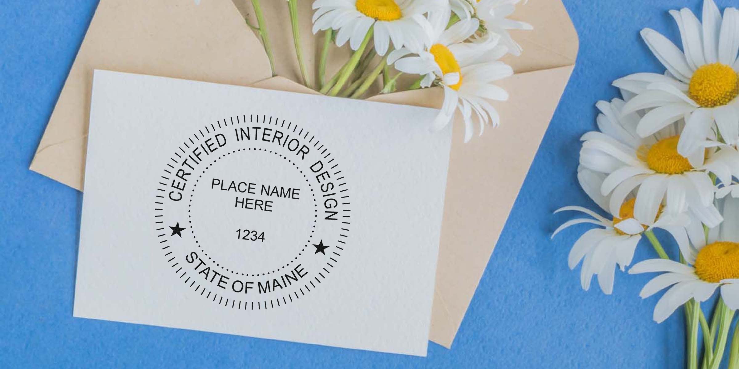 Certified interior design seal on white card with daisies and envelope on blue background, showcasing Maine interior design rules and seal requirements.