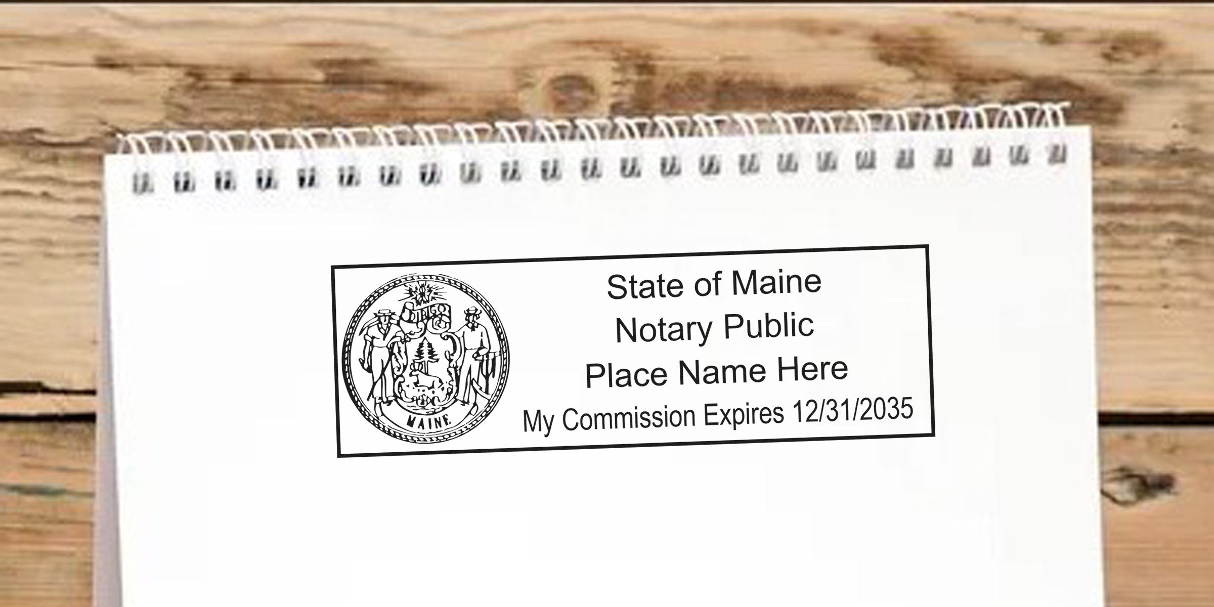 Maine notary public stamp with state seal and commission expiration date on white notepad, showing Maine notary stamp renewal and renewal requirements.