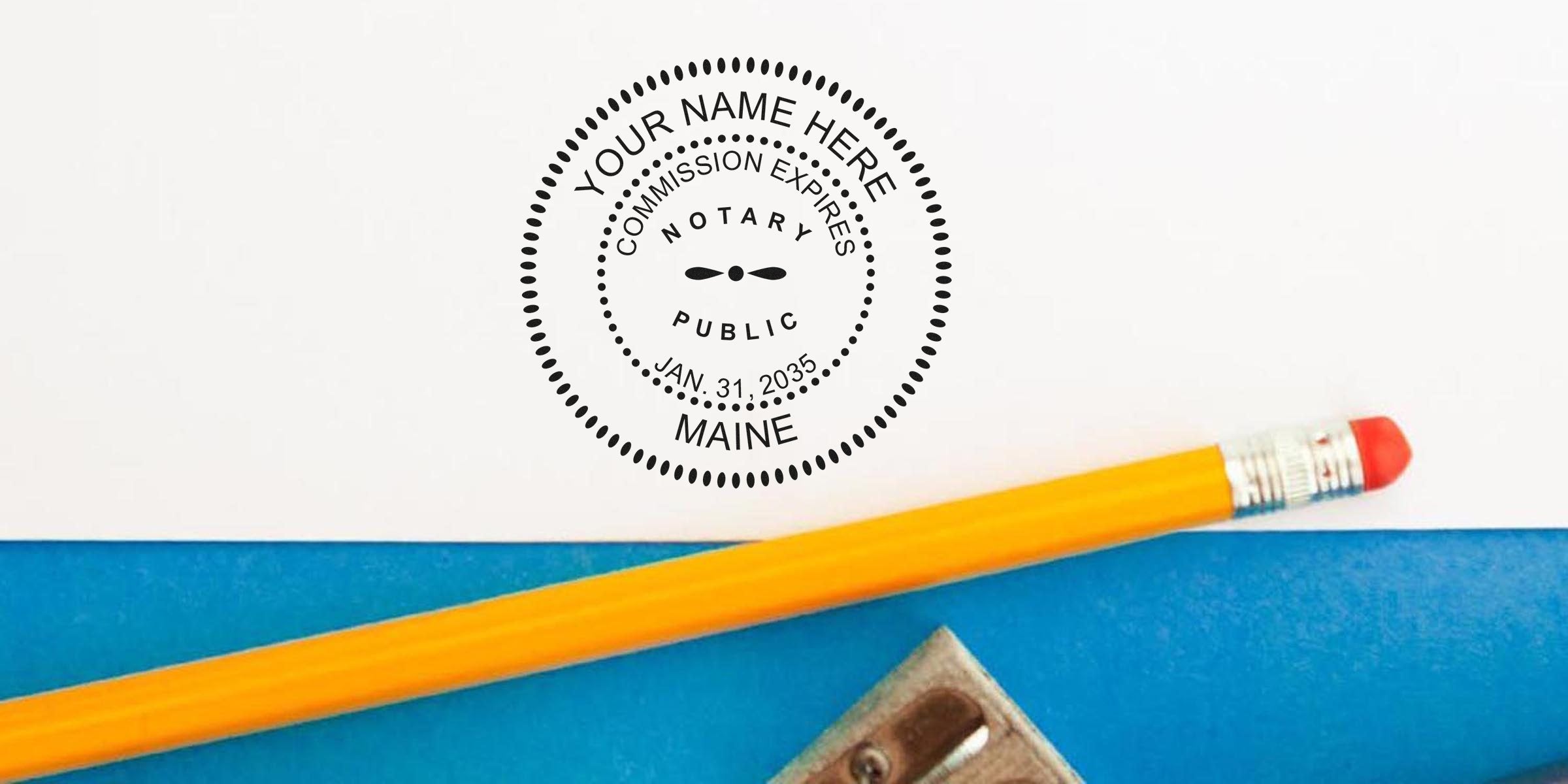 Maine notary seal stamp with commission expiration date on white paper, next to a yellow pencil and sharpener, shown in a notary seal shopping guide.