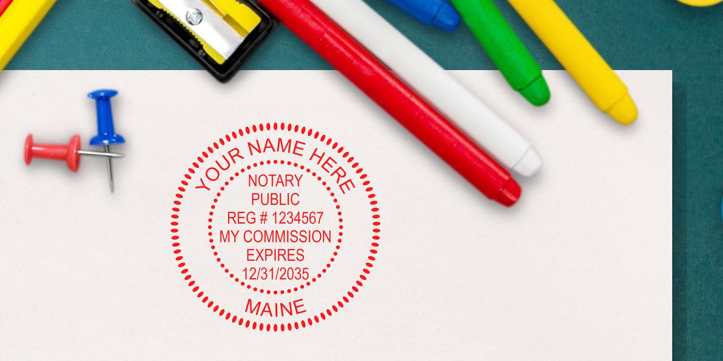 Maine notary stamp on paper, surrounded by colorful markers and push pins, showing a seal with commission expiration and registration number—key for starting your Maine notary kit and journey.