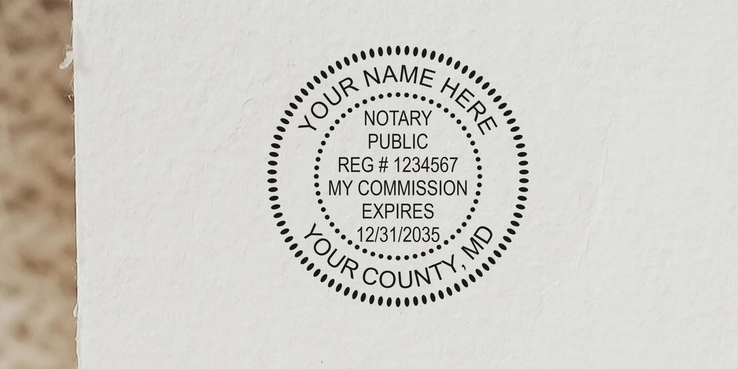 Maryland notary stamp on white paper showing registration, commission expiration, and county; example of notary stamp format.