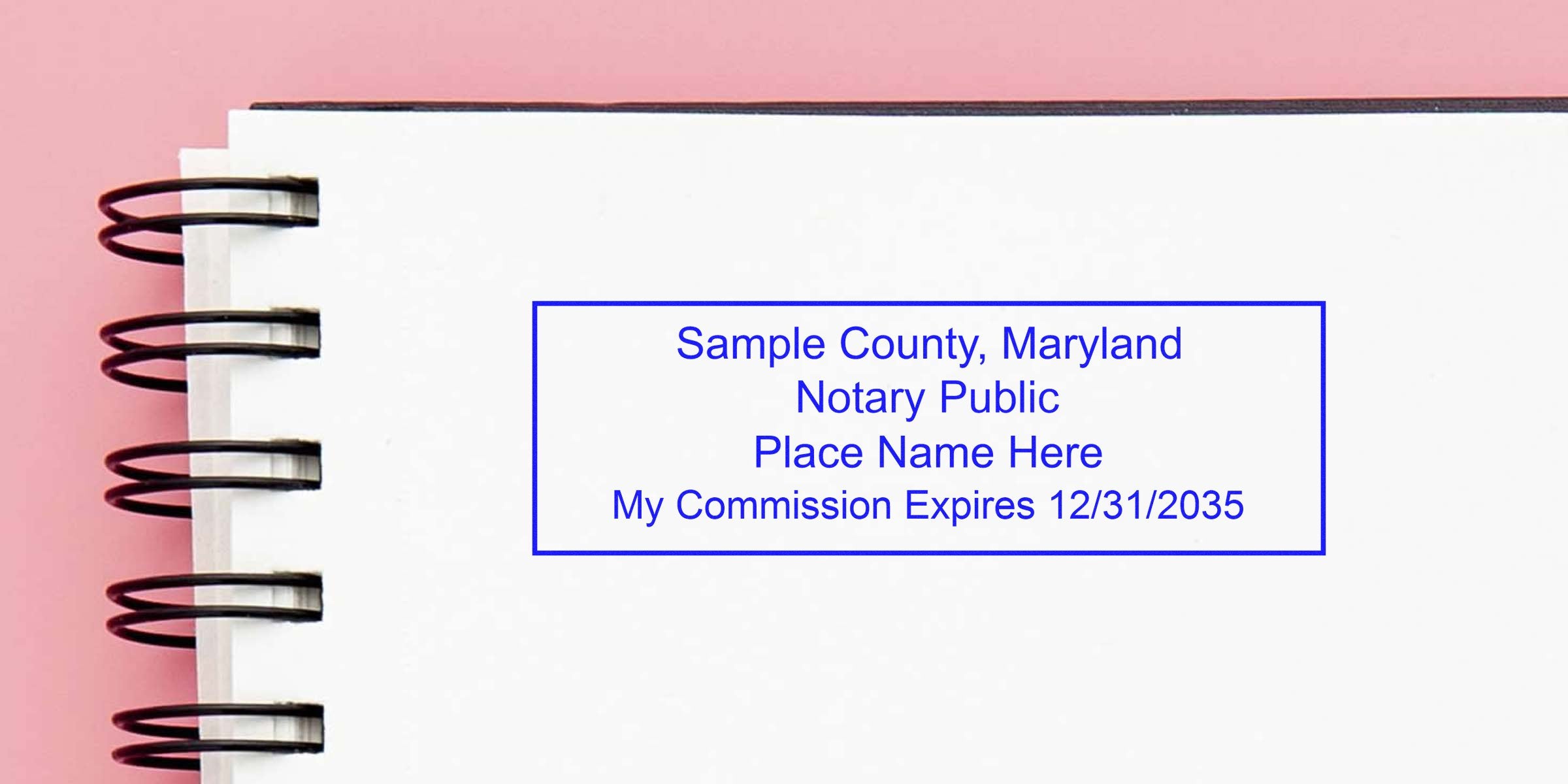 Sample County Maryland notary stamp on white notebook page with commission expiration date, highlighting quality notary supplies.