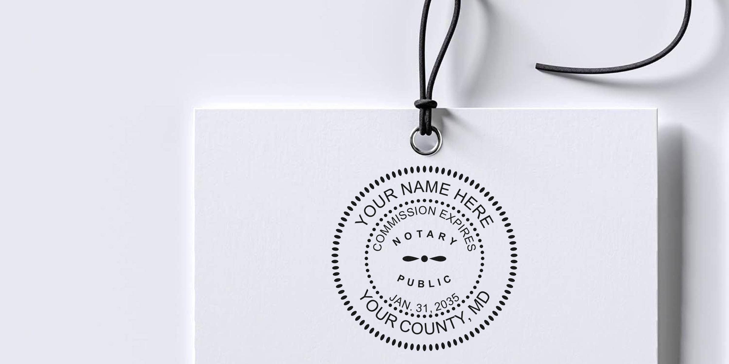 Maryland notary stamp on white tag with black string, showing commission expiration date, compliant with Maryland notary stamp law.