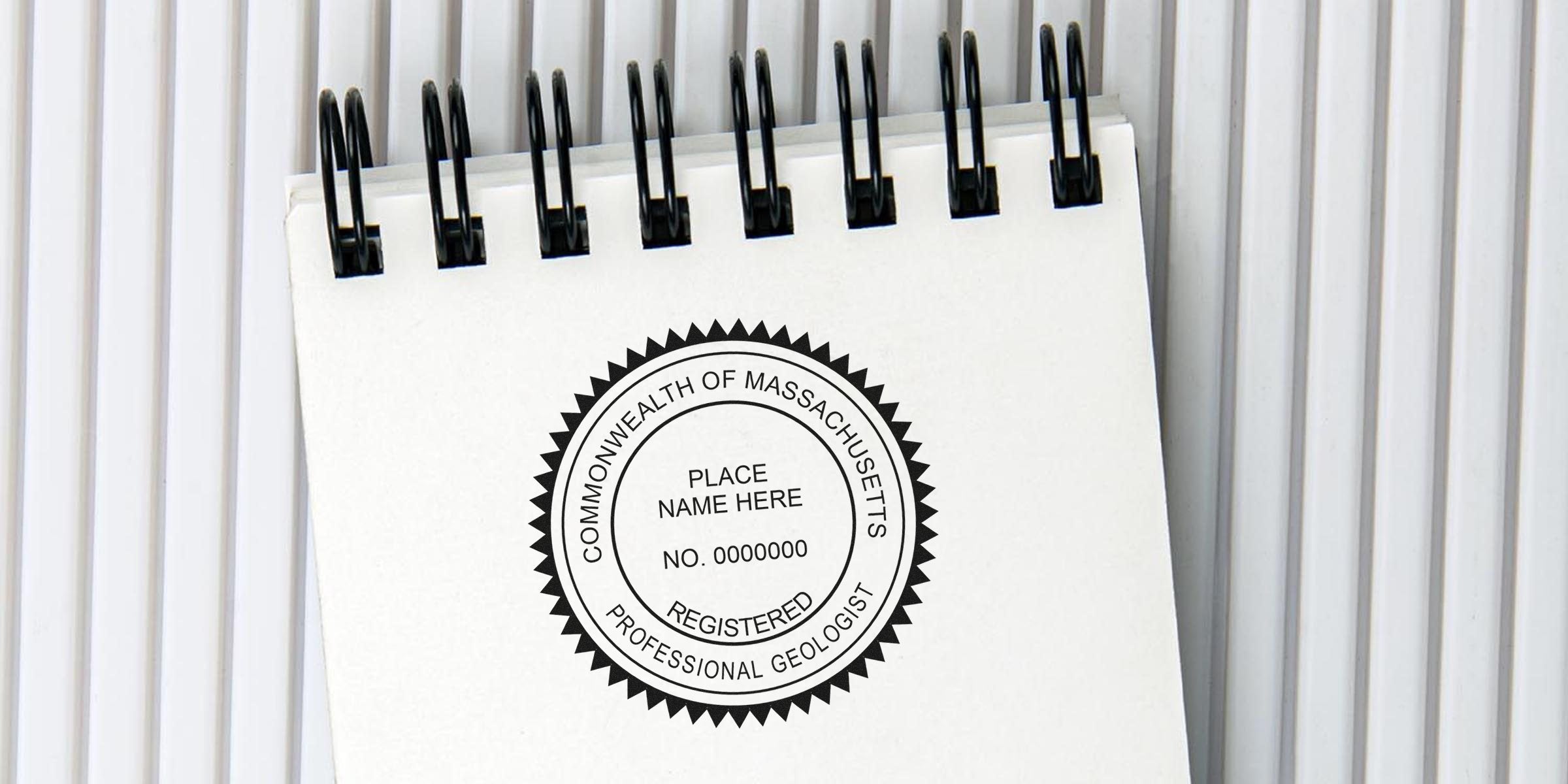 Registered professional geologist seal on white spiral notebook, compliant with Massachusetts geologist stamp requirements and regulations.