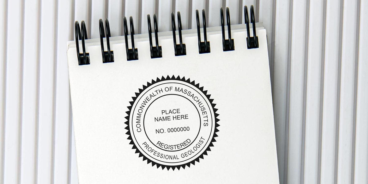 Registered professional geologist seal on white spiral notebook, compliant with Massachusetts geologist stamp requirements and regulations.