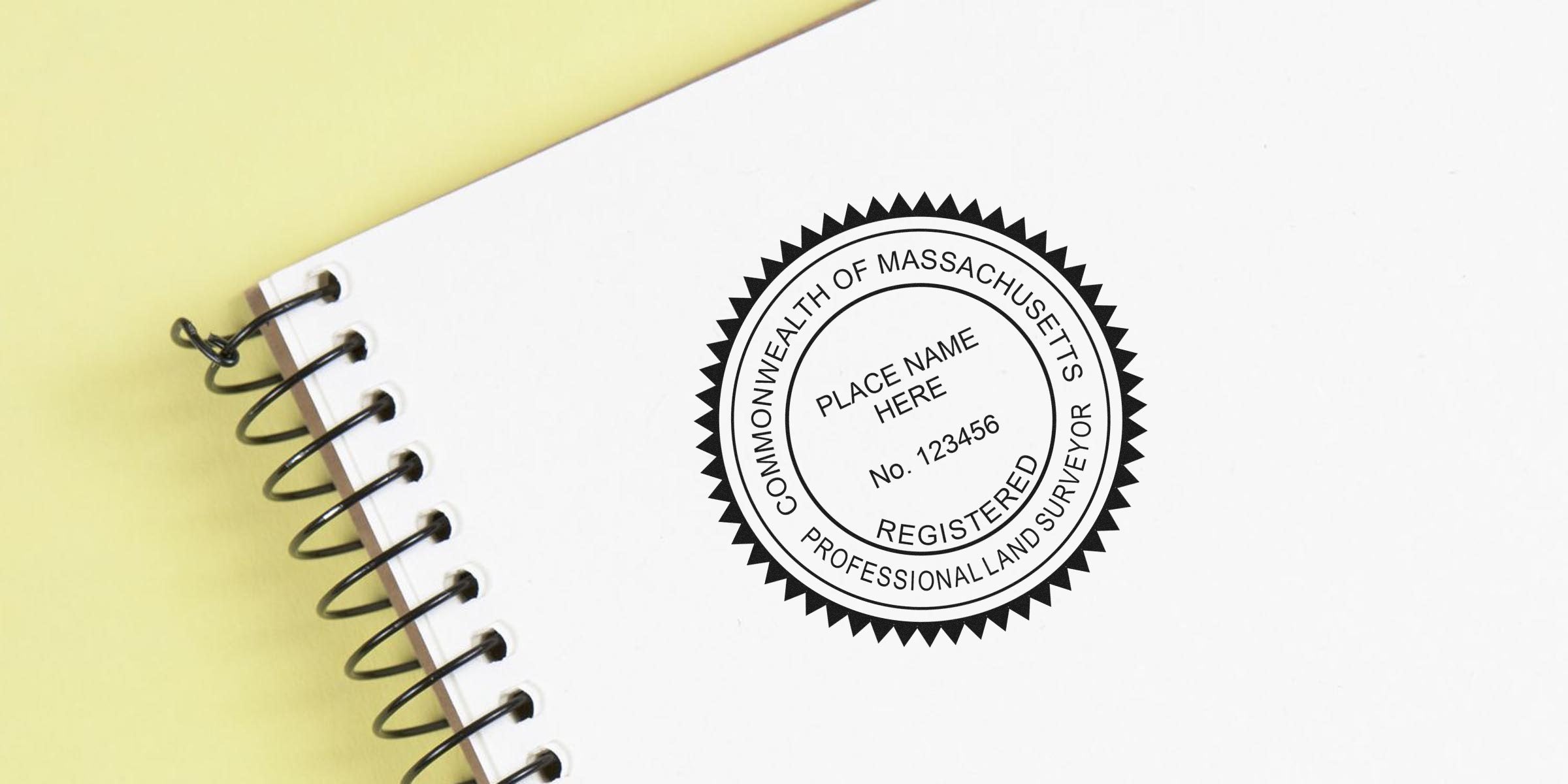 Massachusetts land surveyor stamp shown on a spiral notebook cover, demonstrating correct use by a registered professional land surveyor.