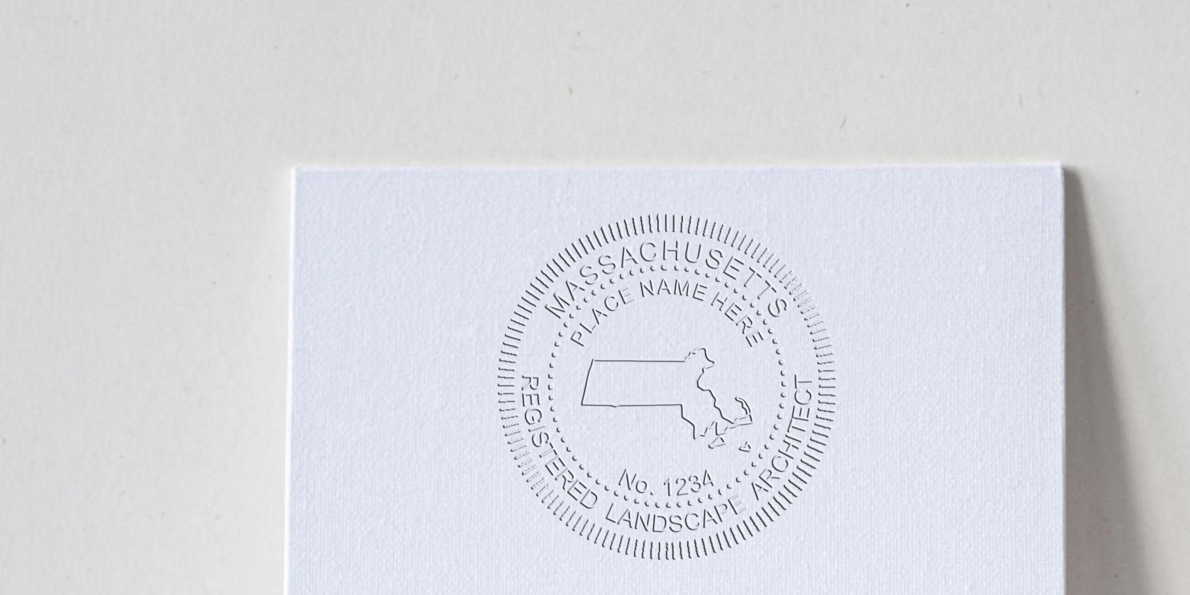 Massachusetts landscape architect stamp embossed on white paper with state map outline and registration number, meeting Massachusetts regulations.