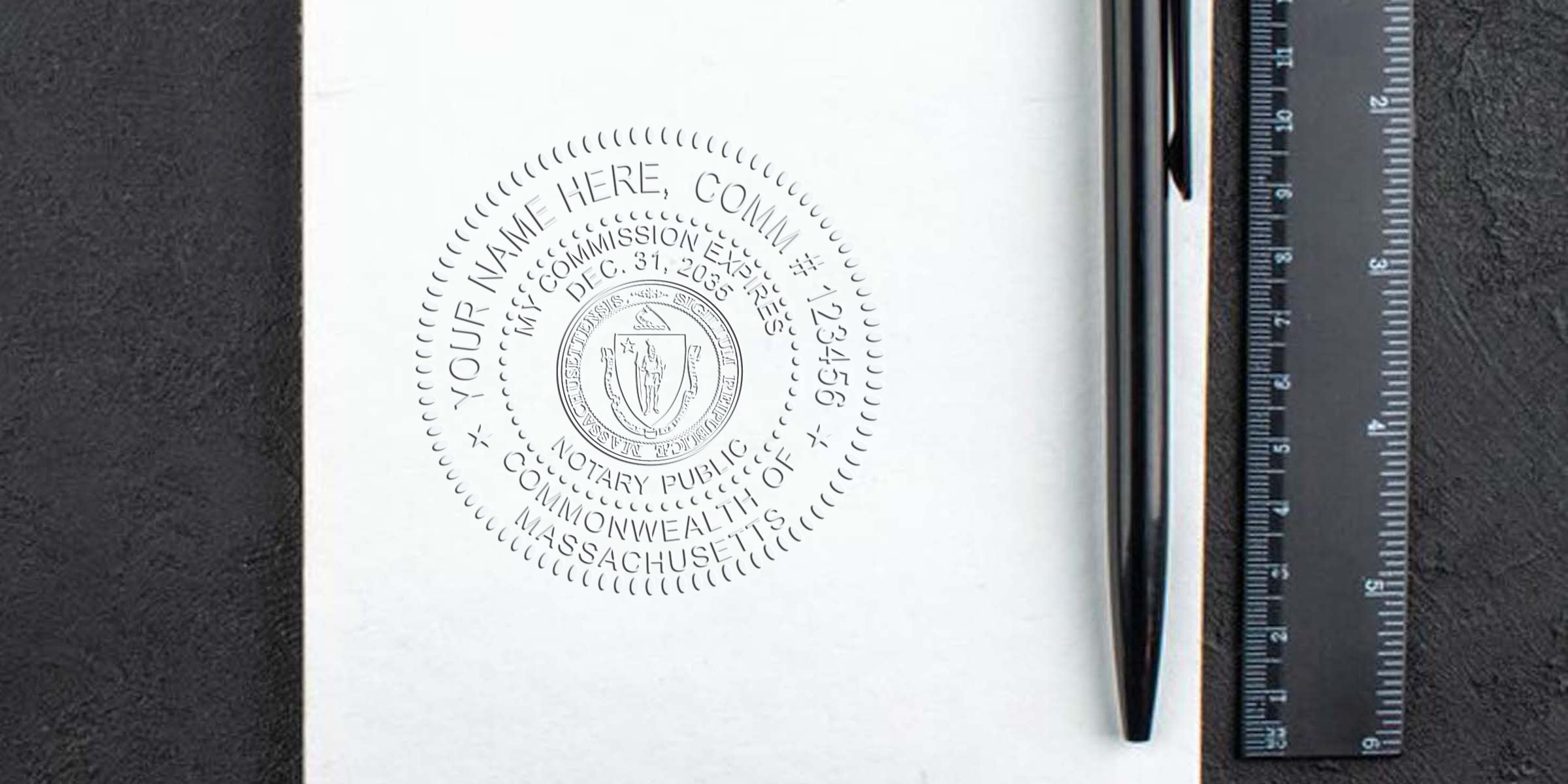 Best Notary Seal MA with Massachusetts notary stamp on white paper, black pen, and ruler on a black surface.