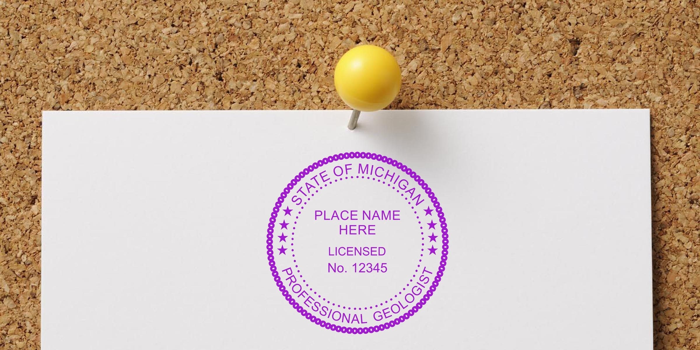 Michigan Geologist Stamp pinned on corkboard with yellow pushpin, displaying professional license; ask about Geologist Stamp cost.