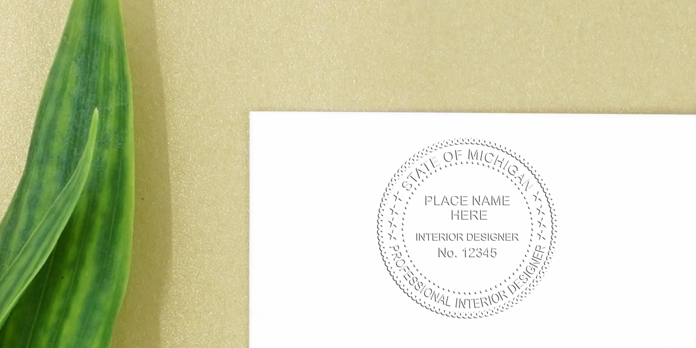 Michigan interior designer stamp embossed on white paper with green leaf on gold background, symbolizing online interior design certification.