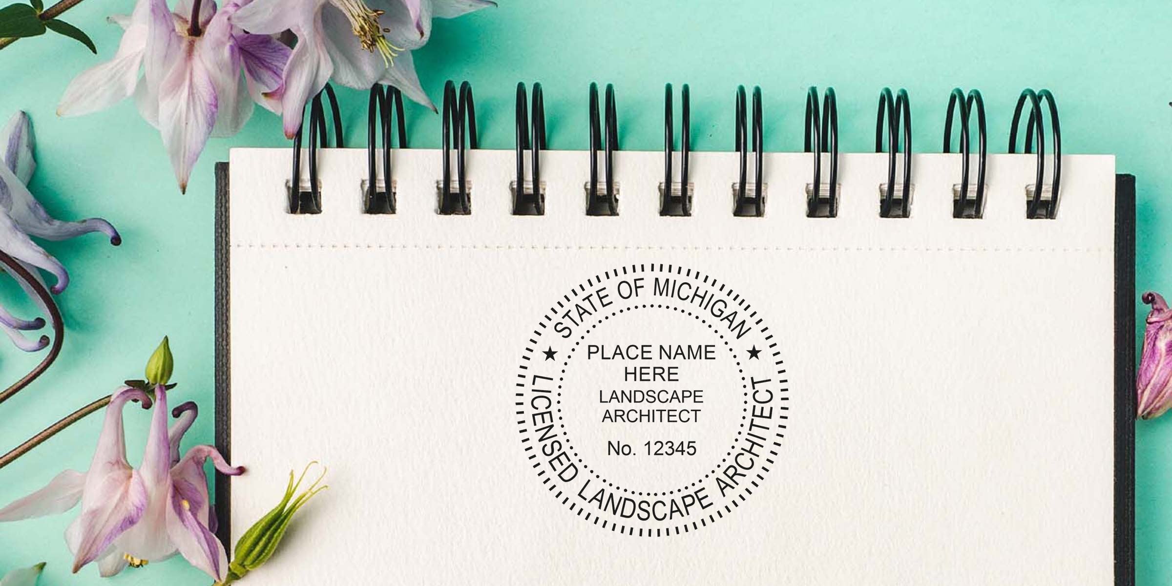 Michigan licensed landscape architect stamp on notebook with floral background, showcasing custom landscape design by a Michigan landscape architect.