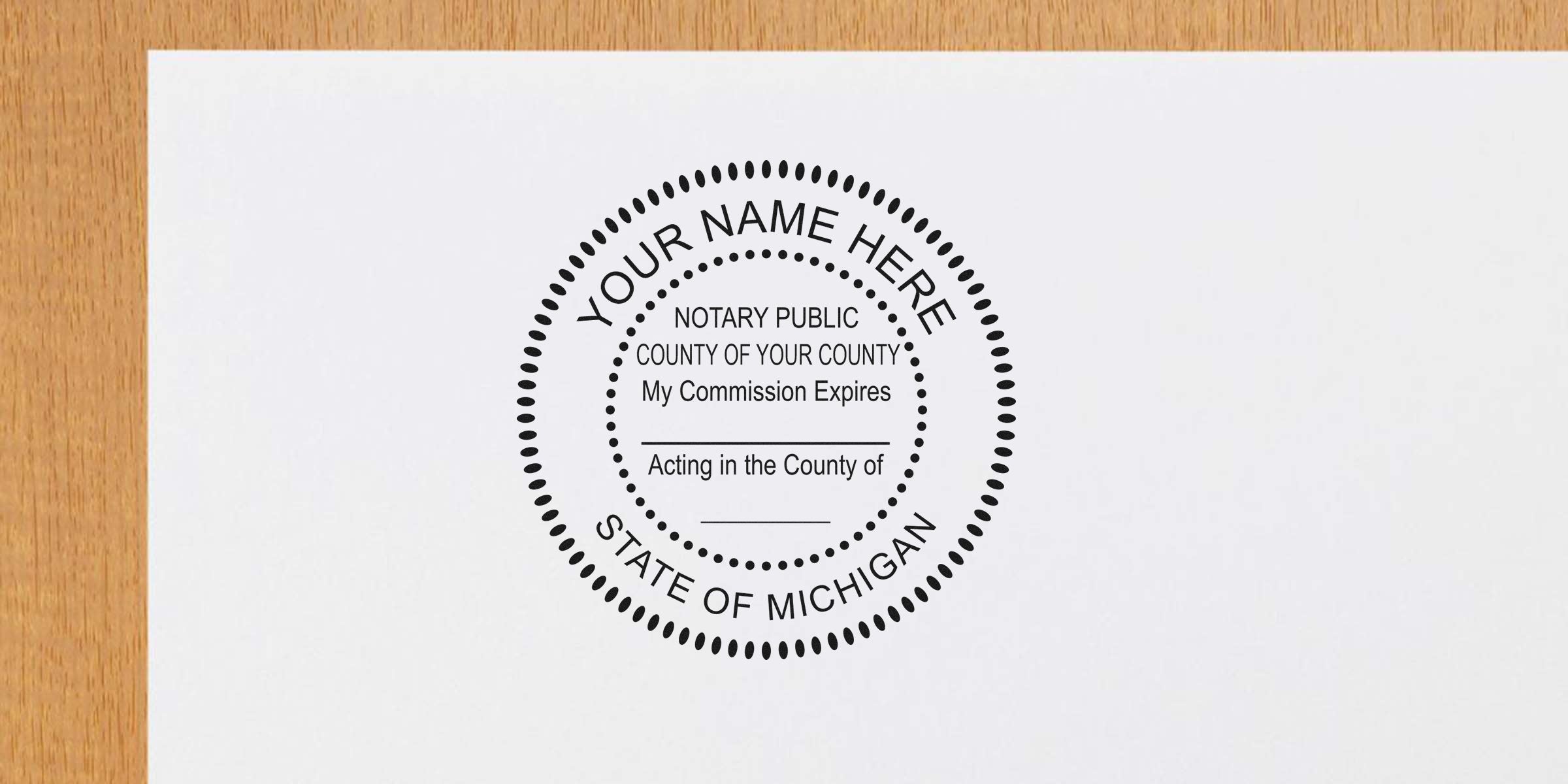 Michigan notary public stamp on white paper showing commission expiration and county, with essential Michigan notary supplies and tools.