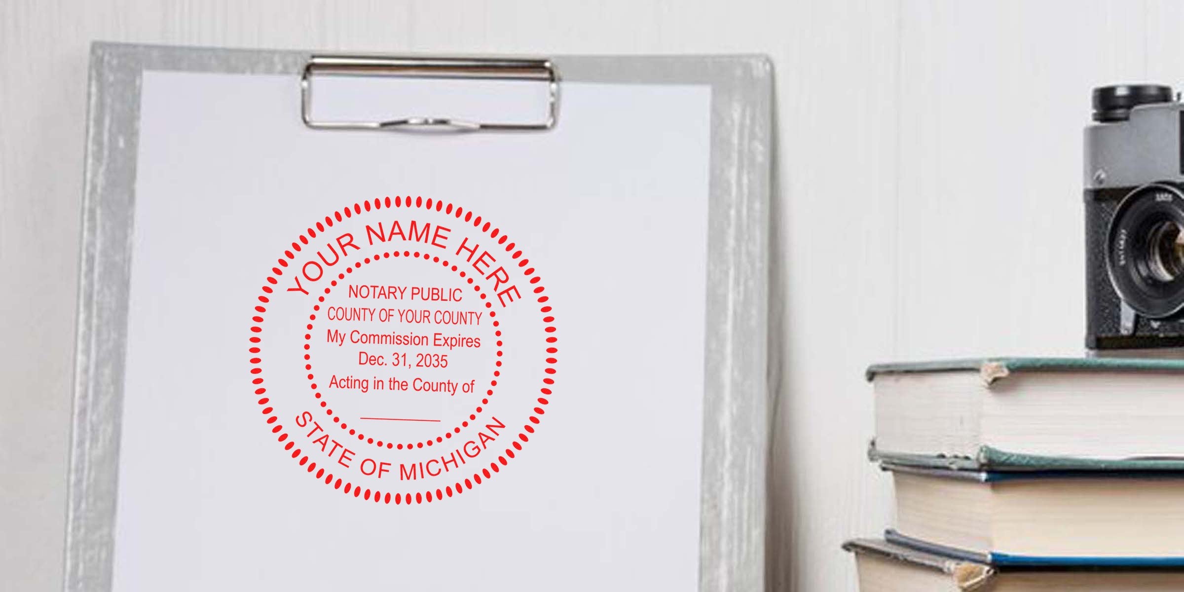 Notary public stamp on clipboard with vintage camera and books, showing Michigan notary commission seal; essential MI notary supplies and must-have tools for official notary stamp design.