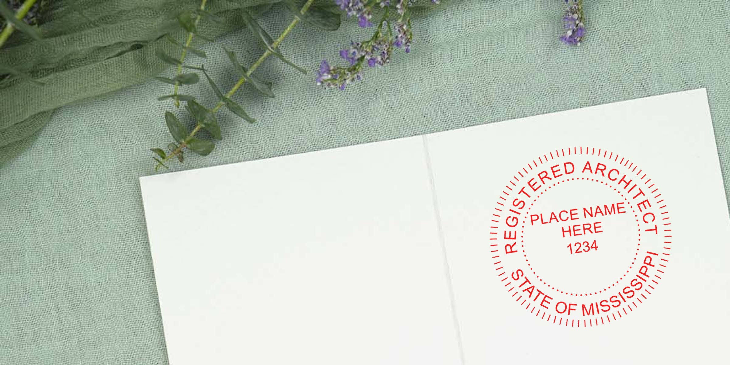 Mississippi architect’s custom seal stamped on white paper, displayed on green fabric with purple flowers, emphasizing Mississippi architect requirements.