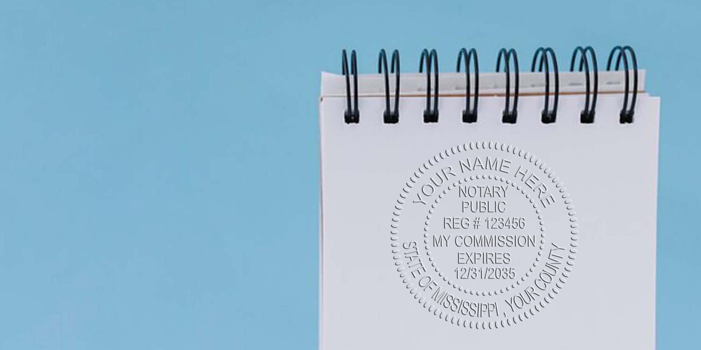 Mississippi notary stamp embossed on a white spiral notebook against a blue background, showing an official notary stamp format sample for legal documents.