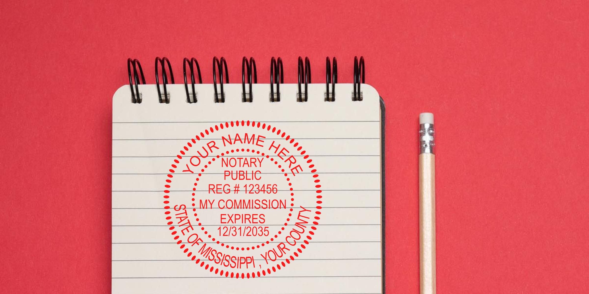 Mississippi notary stamp on spiral notebook with pencil on red background, displaying notary commission expiration and official requirements.