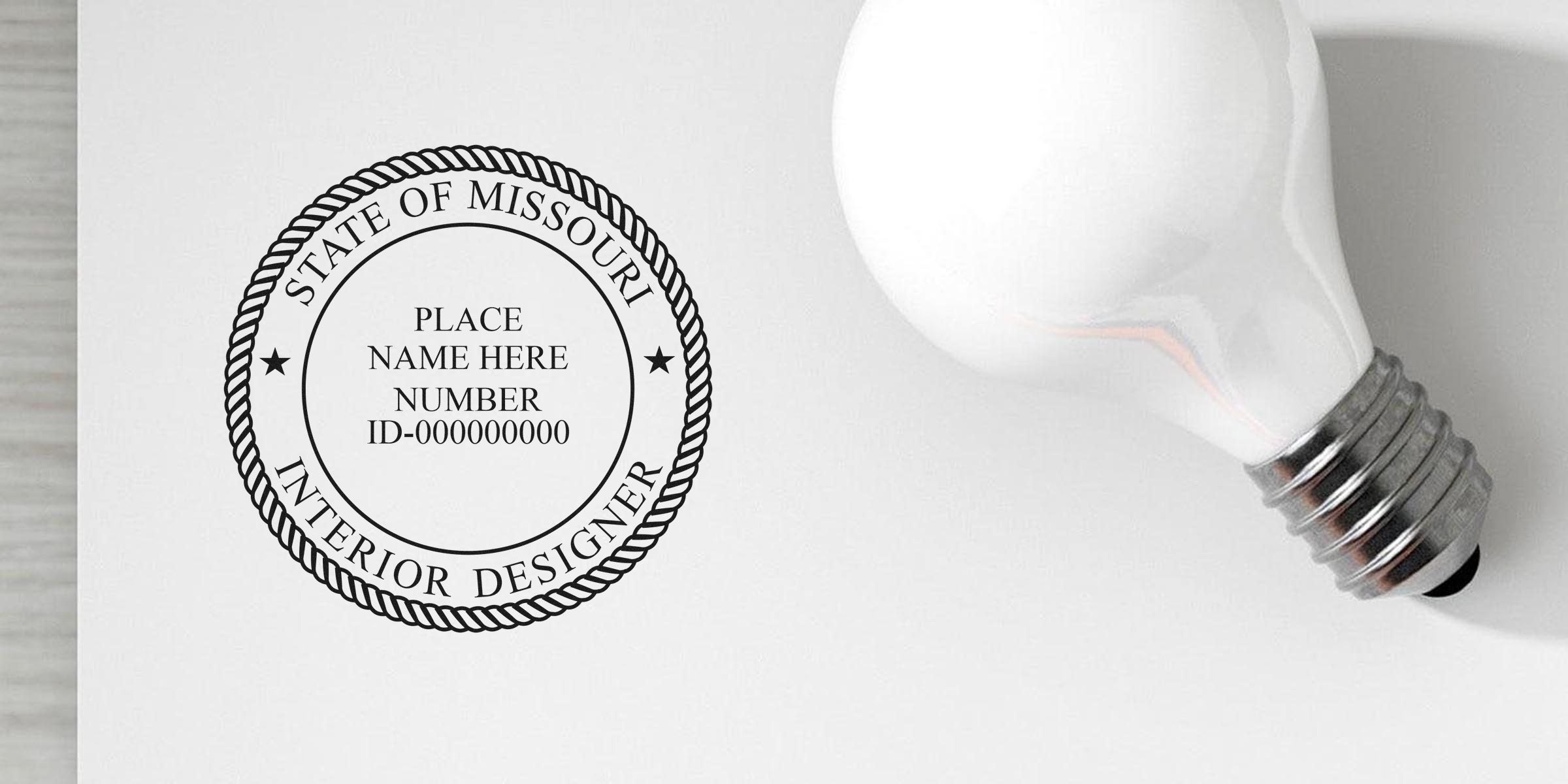 Missouri interior designer stamp embosser with state seal and light bulb on white background.