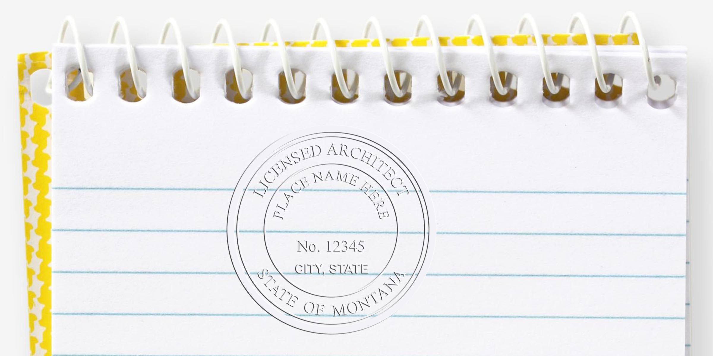 Montana architect stamps with unique designs on a spiral notebook page for architectural certification and license verification.