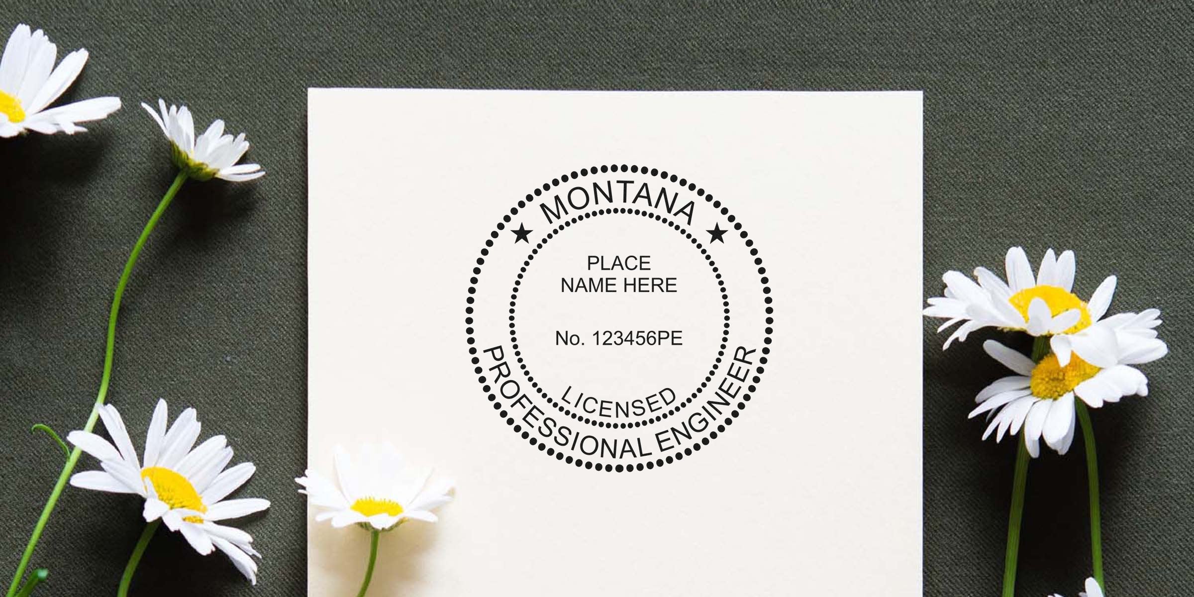 Montana licensed professional engineer stamp on white paper with daisies, set against dark fabric, showcasing trusted Montana engineer stamps.